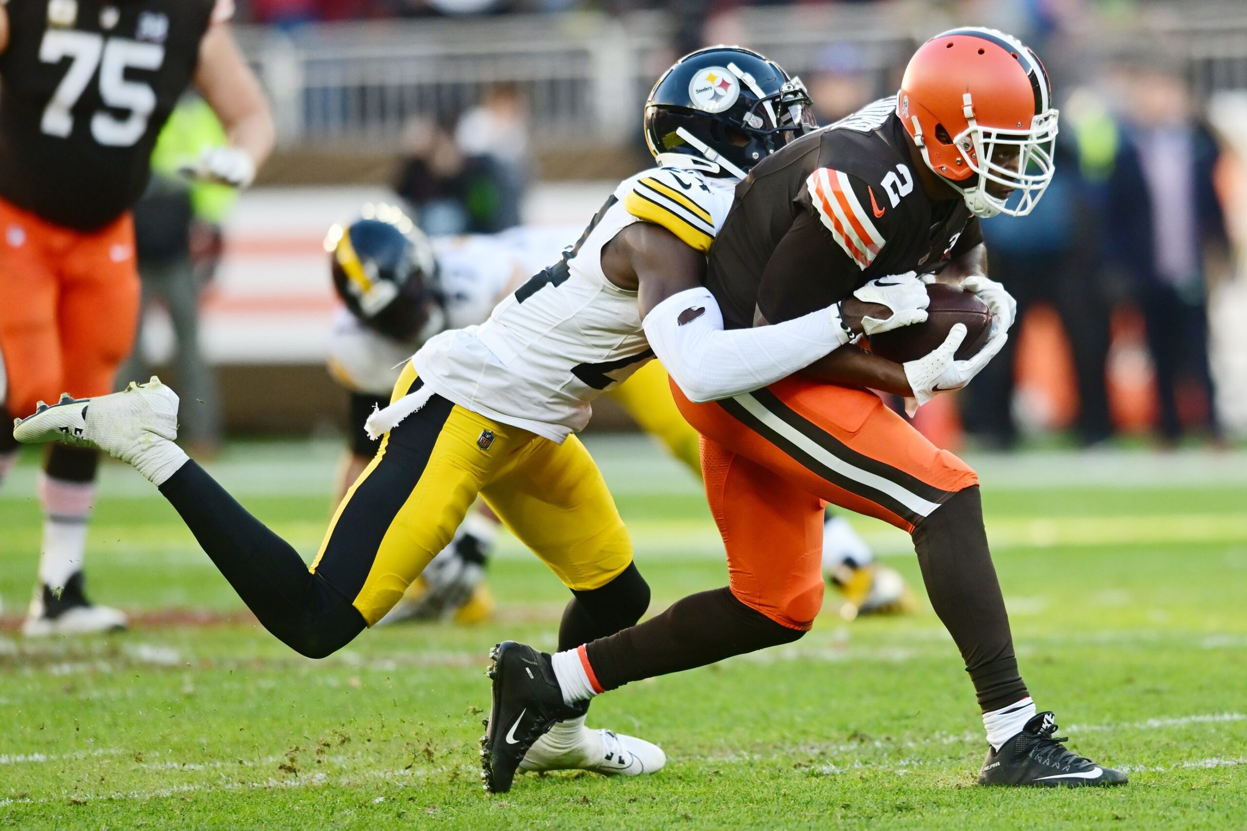 Nov 19, 2023; Cleveland, Ohio, USA; Pittsburgh Steelers cornerback Joey Porter Jr. (24) tackles Cleveland Browns wide receiver Amari Cooper (2) during the second half at Cleveland Browns Stadium. Mandatory Credit: Ken Blaze-Imagn Images