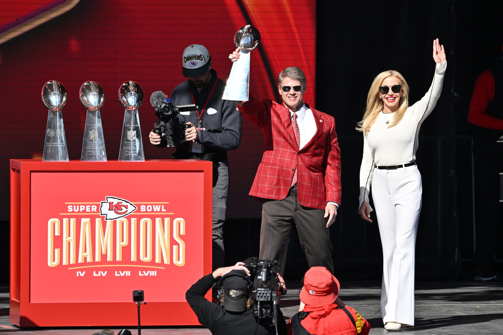 Feb 14, 2024; Kansas City, MO, USA; Kansas City Chiefs chairman and co-owner Clark Hunt holds the Vince Lombardi Trophy on stage with his wife Tavia during the celebration of the Kansas City Chiefs winning Super Bowl LVIII. Mandatory Credit: David Rainey-Imagn Images