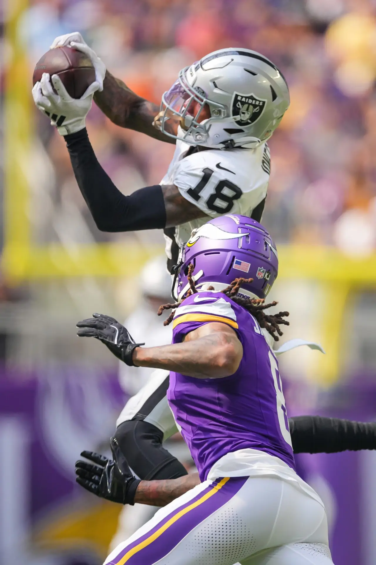 Aug 10, 2024; Minneapolis, Minnesota, USA; Las Vegas Raiders cornerback Jack Jones (18) interecpts a pass from Minnesota Vikings quarterback J.J. McCarthy (9) in the second quarter at U.S. Bank Stadium. Mandatory Credit: Brad Rempel-Imagn Images