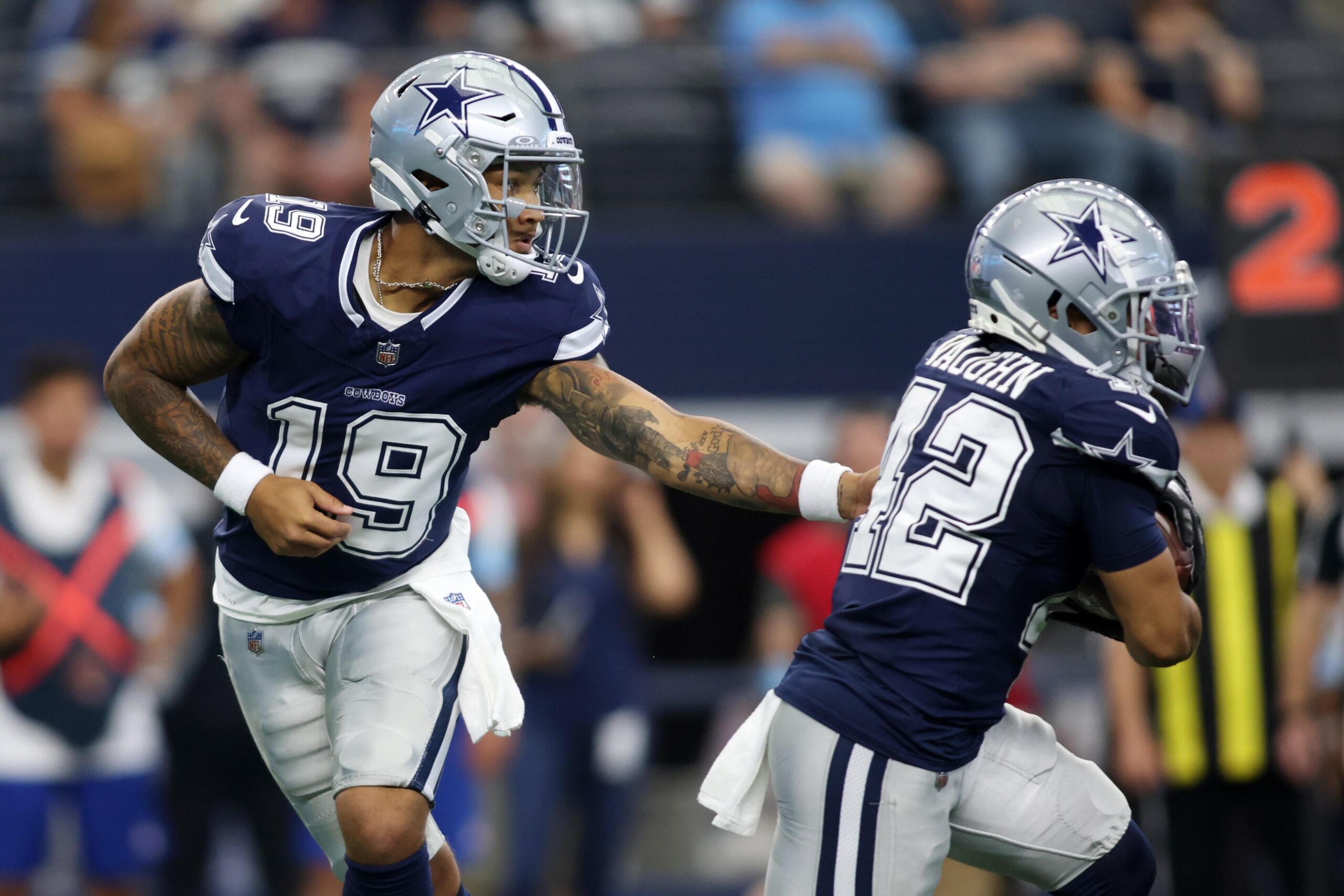 Aug 24, 2024; Arlington, Texas, USA; Dallas Cowboys quarterback Trey Lance (19) hands the ball off to running back Deuce Vaughn (42) in the first quarter against the Los Angeles Chargers at AT&T Stadium. Mandatory Credit: Tim Heitman-Imagn Images