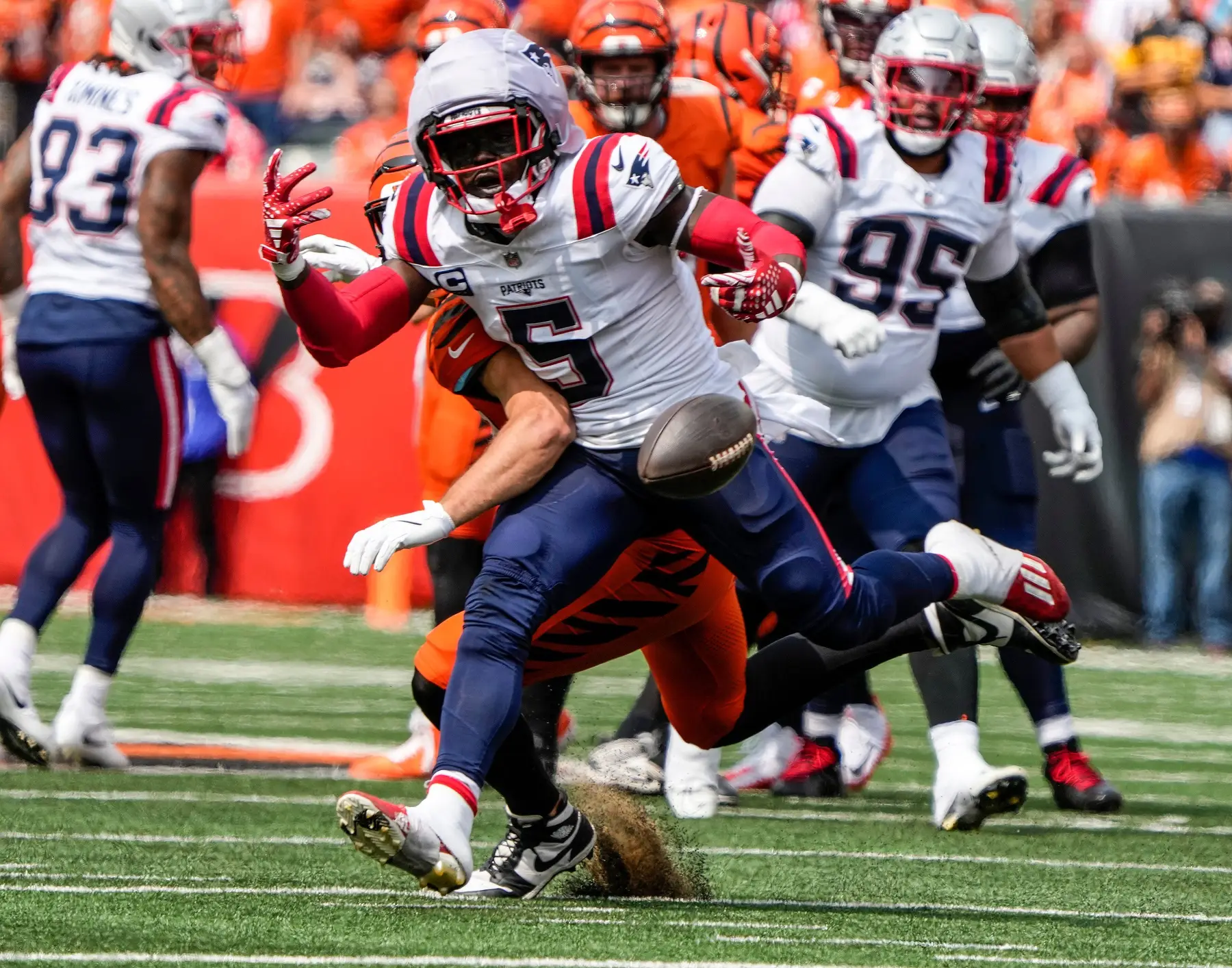 A pass thrown from Cincinnati Bengals quarterback Joe Burrow intended for Bengals tight end Tanner Hudson is almost caught by New England Patriots safety Jabrill Peppers (5) during the Bengals home opener against the New England Patriots at Paycor Stadium Sunday, September 8, 20224