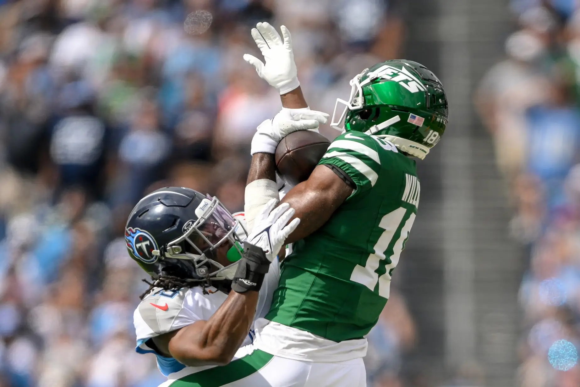 Sep 15, 2024; Nashville, Tennessee, USA; New York Jets wide receiver Allen Lazard (10) makes a catch over Tennessee Titans cornerback Roger McCreary (21) during the second half at Nissan Stadium. Mandatory Credit: Steve Roberts-Imagn Images