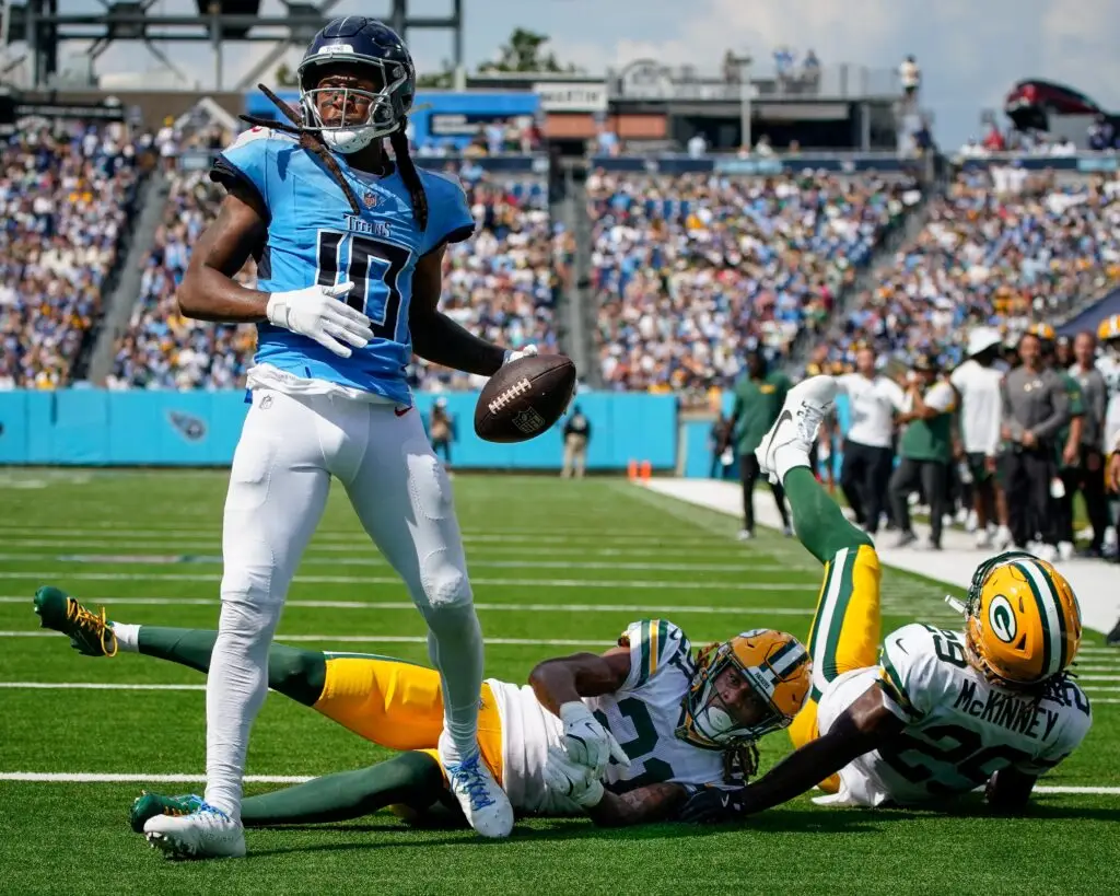 Tennessee Titans wide receiver DeAndre Hopkins (10) scores a touchdown past Green Bay Packers cornerback Eric Stokes (21) and safety Xavier McKinney (29) during the third quarter at Nissan Stadium in Nashville, Tenn., Sunday, Sept. 22, 2024 (Commanders)