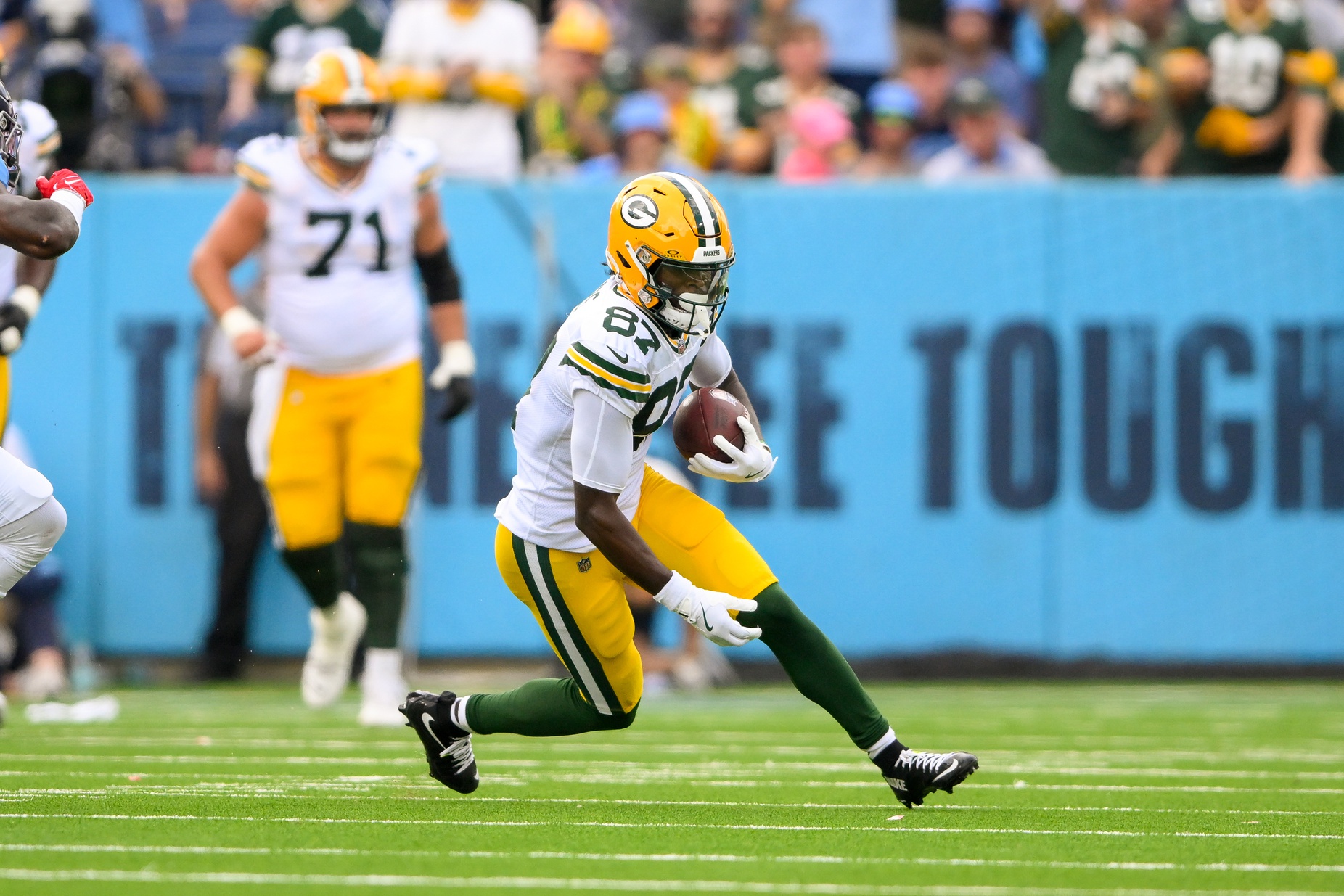 Sep 22, 2024; Nashville, Tennessee, USA; Green Bay Packers wide receiver Romeo Doubs (87) makes a catch and runs the ball against the Tennessee Titans during the first half at Nissan Stadium. Mandatory Credit: Steve Roberts-Imagn Images