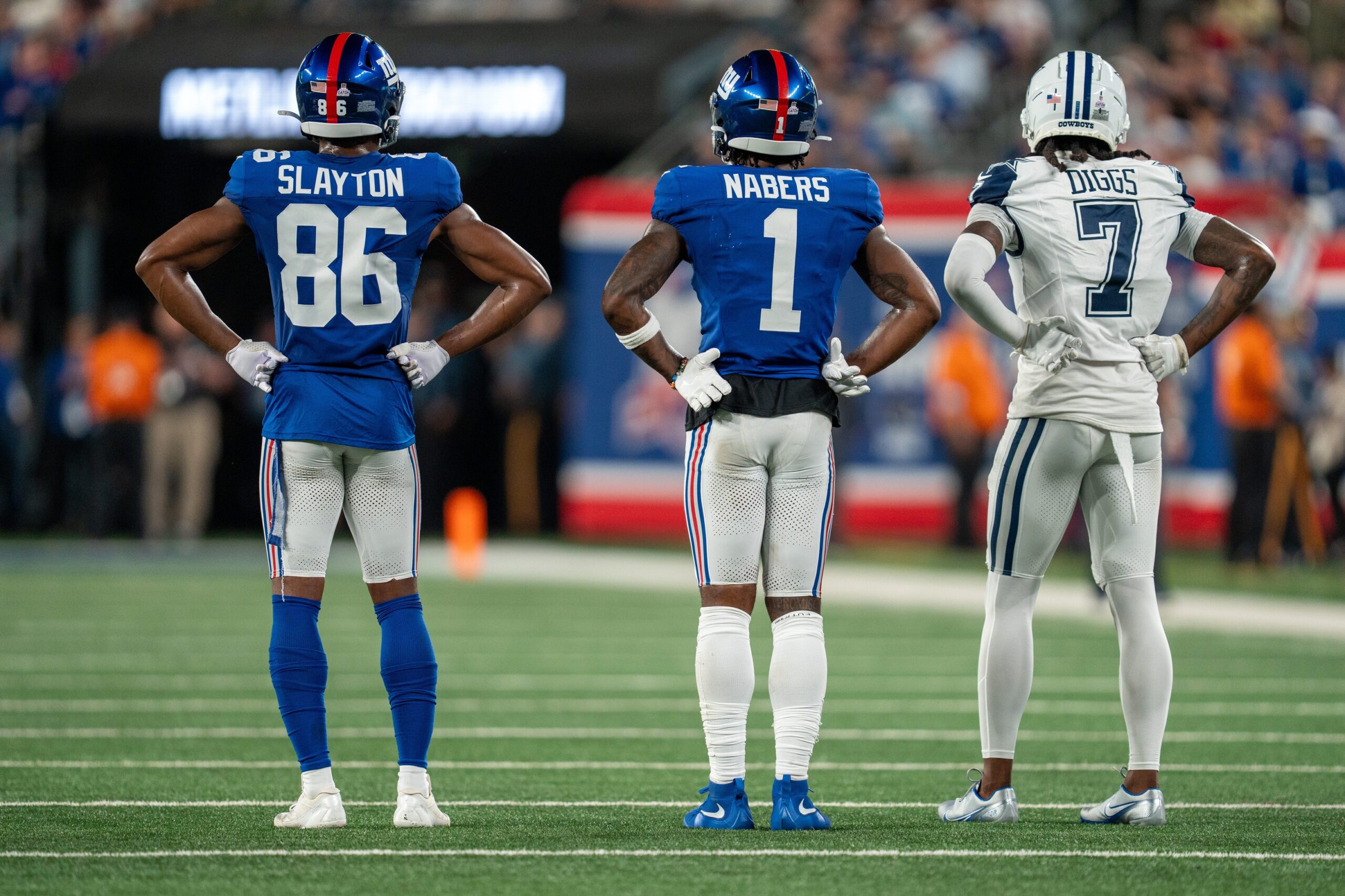 Sep 26, 2024; East Rutherford, NJ, US; New York Giants wide receiver Darius Slayton (86), New York Giants wide receiver Malik Nabers (1), and Dallas Cowboys cornerback Trevon Diggs (7) stand in a line on the field at MetLife Stadium. Mandatory Credit: Julian Guadalupe-NorthJersey.com