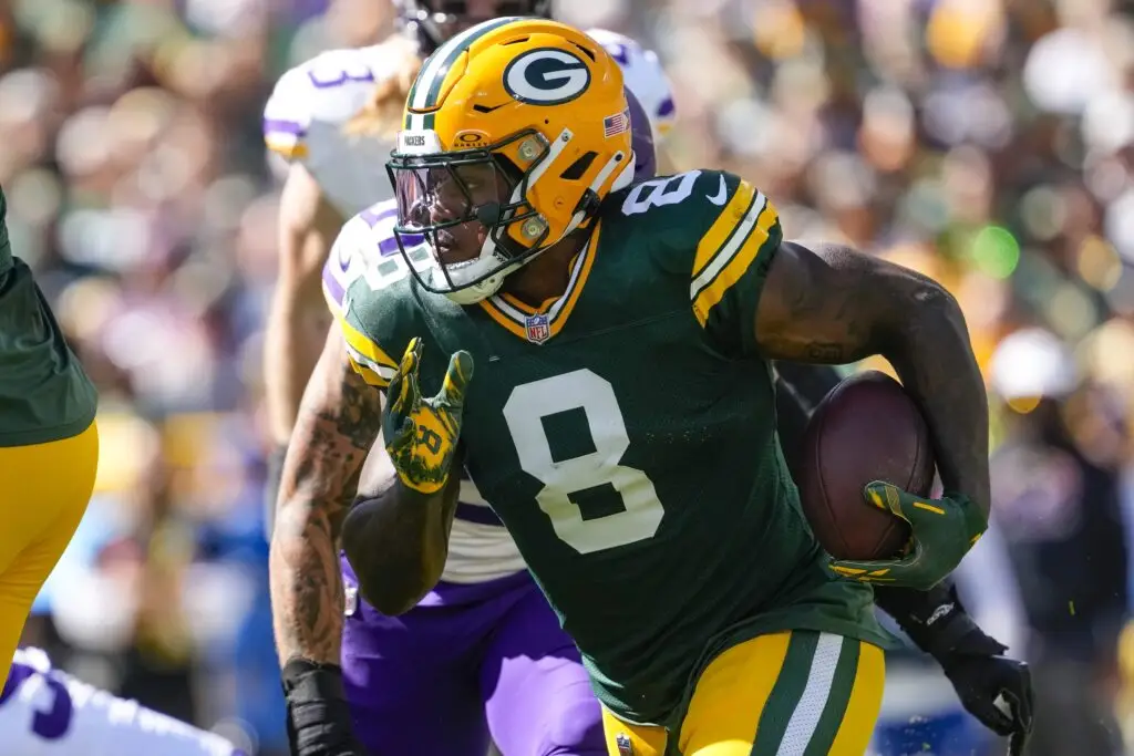 Sep 29, 2024; Green Bay, Wisconsin, USA; Green Bay Packers running back Josh Jacobs (8) rushes with the football during the first quarter against the Minnesota Vikings at Lambeau Field. Mandatory Credit: Jeff Hanisch-Imagn Images