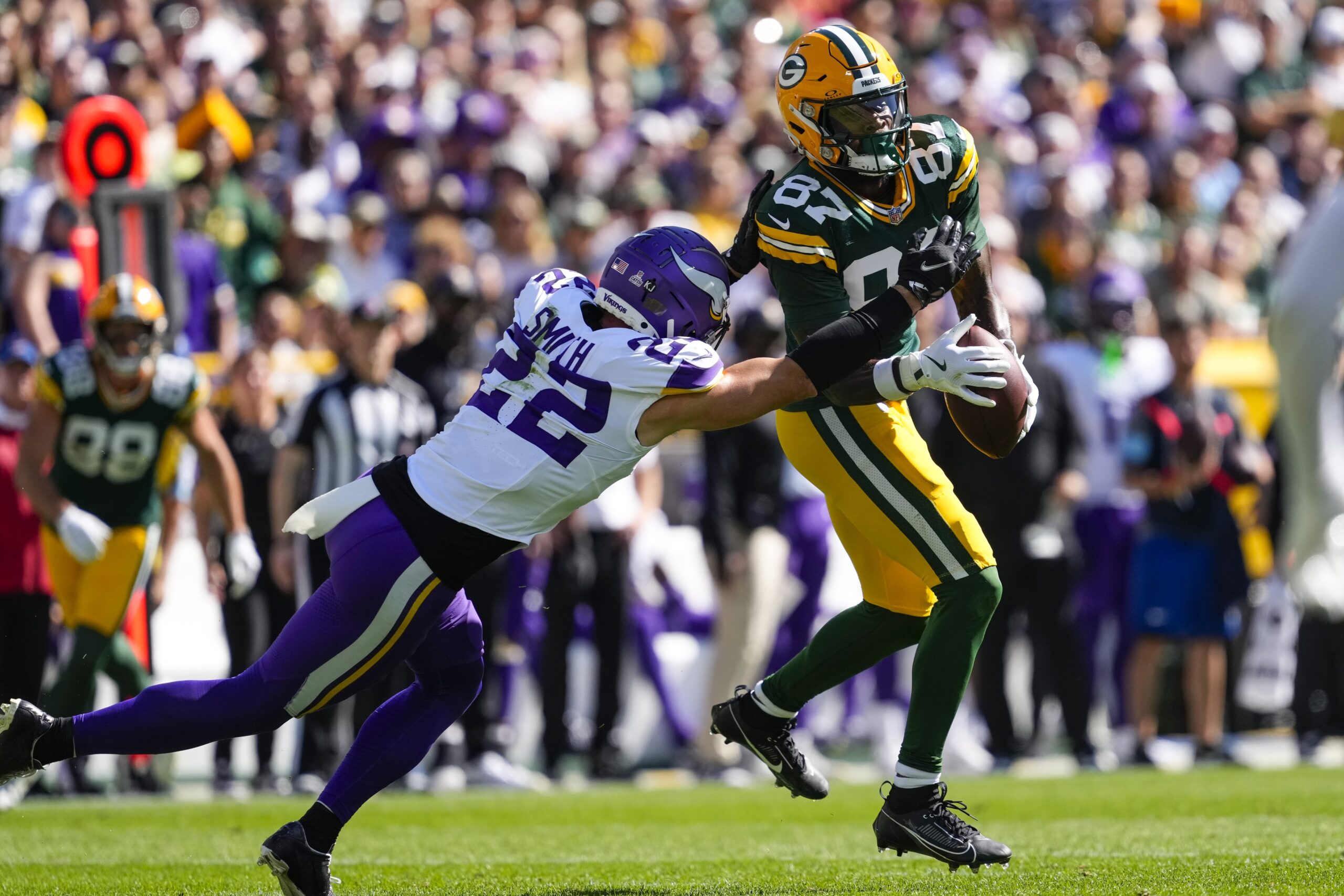 Sep 29, 2024; Green Bay, Wisconsin, USA; Minnesota Vikings safety Harrison Smith (22) breaks up the pass intended for Green Bay Packers wide receiver Romeo Doubs (87) during the second quarter at Lambeau Field. Mandatory Credit: Jeff Hanisch-Imagn Images