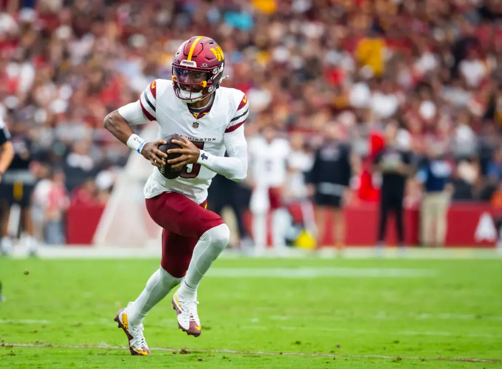 Sep 29, 2024; Glendale, Arizona, USA; Washington Commanders quarterback Jayden Daniels (5) against the Arizona Cardinals at State Farm Stadium. Mandatory Credit: Mark J. Rebilas-Imagn Images