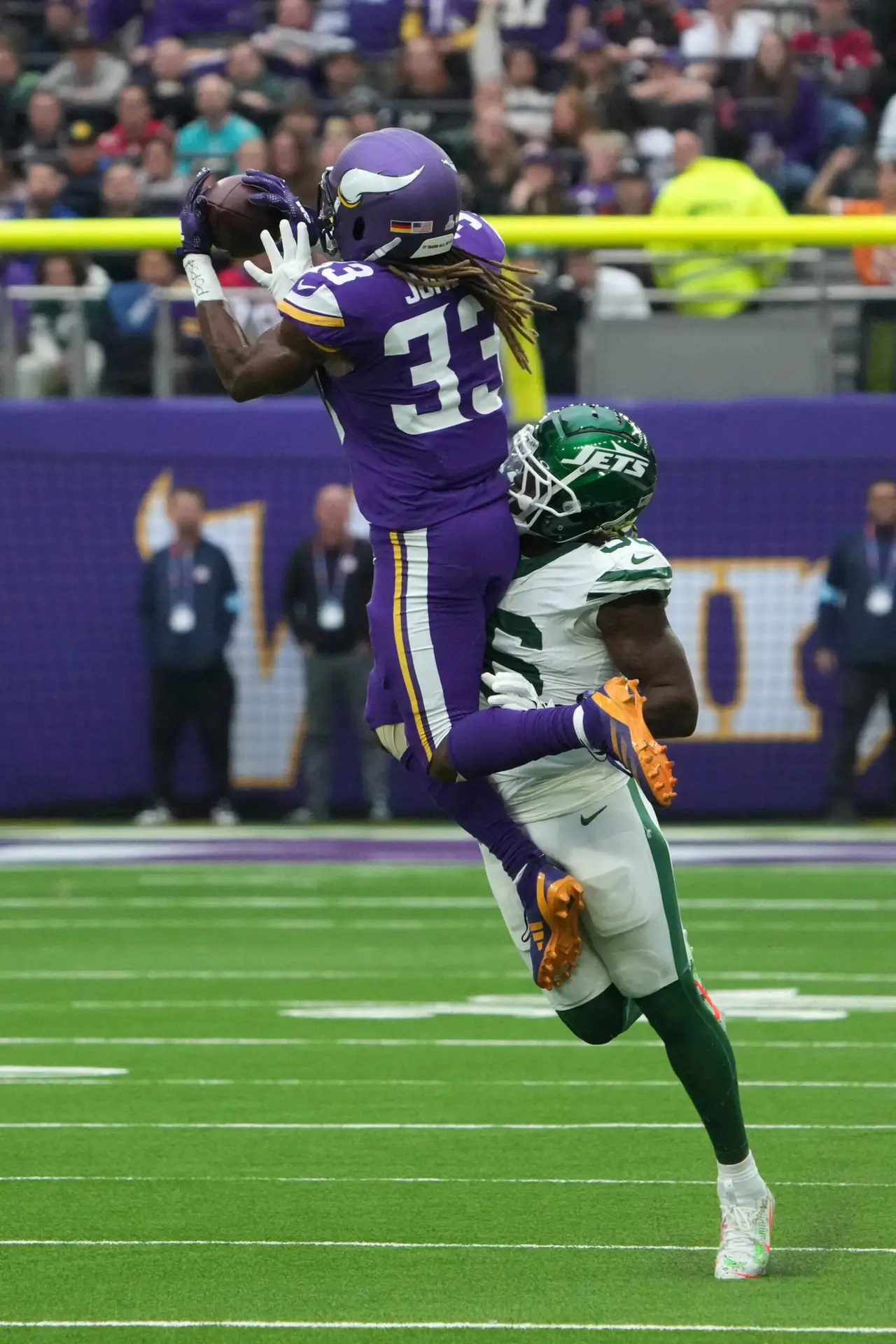 Oct 6, 2024; London, United Kingdom; Minnesota Vikings running back Aaron Jones (33) catches the ball against New York Jets linebacker Quincy Williams (56) in the first half at Tottenham Hotspur Stadium. Mandatory Credit: Kirby Lee-Imagn Images