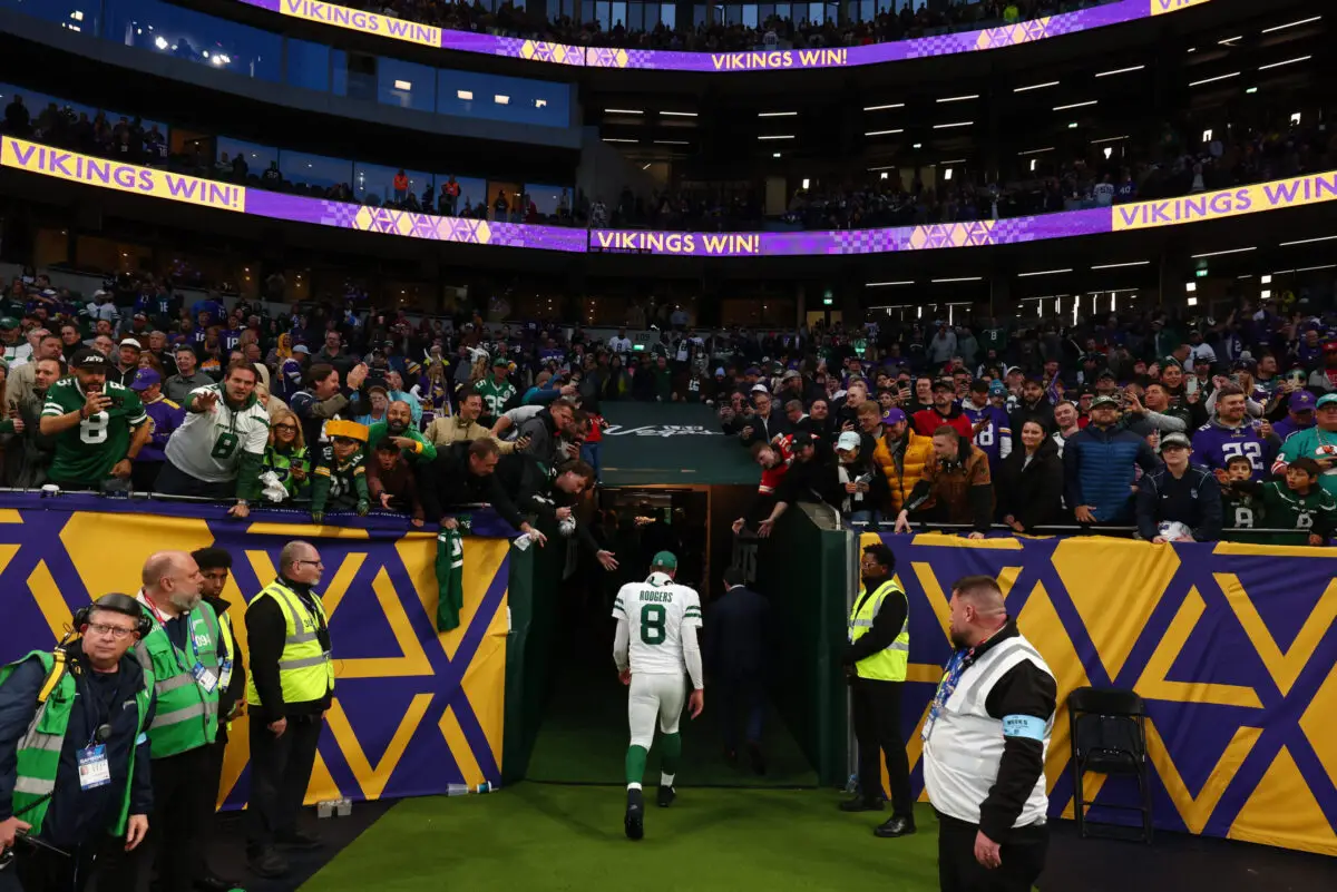 Oct 6, 2024; Tottenham, ENG; A dejected New York Jets quarterback Aaron Rodgers (8) walks back to the locker room after the 17-23 defeat to the Minnesota Vikings at Tottenham Hotspur Stadium. Mandatory Credit: Shaun Brooks-Imagn Images