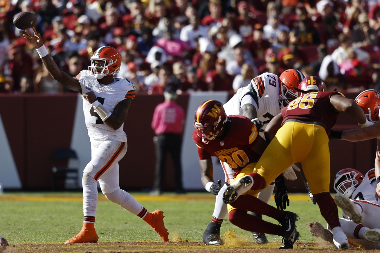 Oct 6, 2024; Landover, Maryland, USA; Cleveland Browns quarterback Deshaun Watson (4) passes the ball as Washington Commanders defensive end Javontae Jean-Baptiste (90) chases during the third quarter at NorthWest Stadium. Mandatory Credit: Geoff Burke-Imagn Images