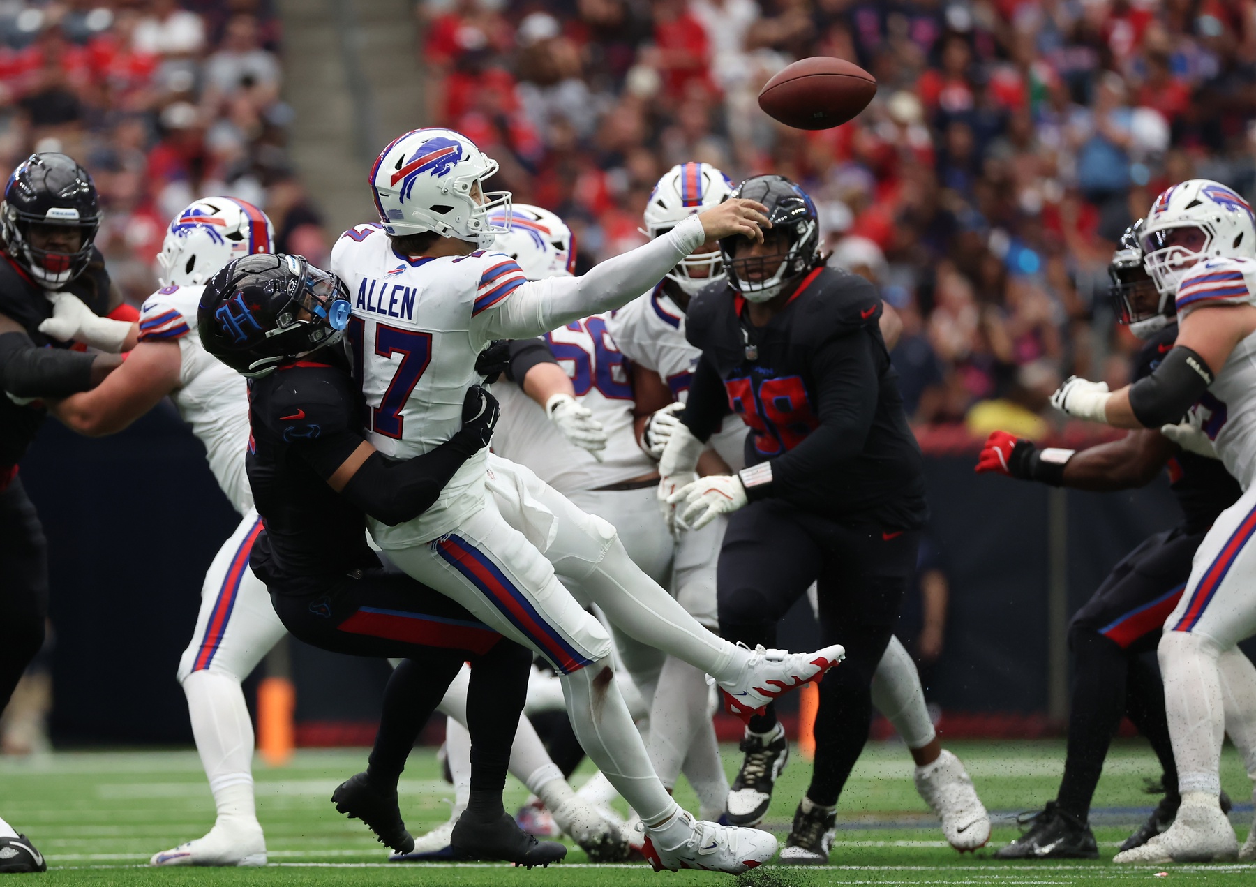 Oct 6, 2024; Houston, Texas, USA; Buffalo Bills quarterback Josh Allen (17) gets hit by Houston Texans safety Jalen Pitre (5) in the second half at NRG Stadium. Mandatory Credit: Thomas Shea-Imagn Images