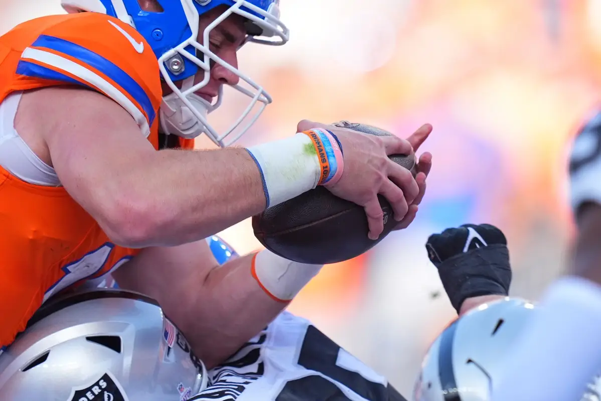 Oct 6, 2024; Denver, Colorado, USA; Denver Broncos quarterback Bo Nix (10) leaps for a touchdown in the fourth quarter against the Las Vegas Raiders at Empower Field at Mile High. Mandatory Credit: Ron Chenoy-Imagn Images