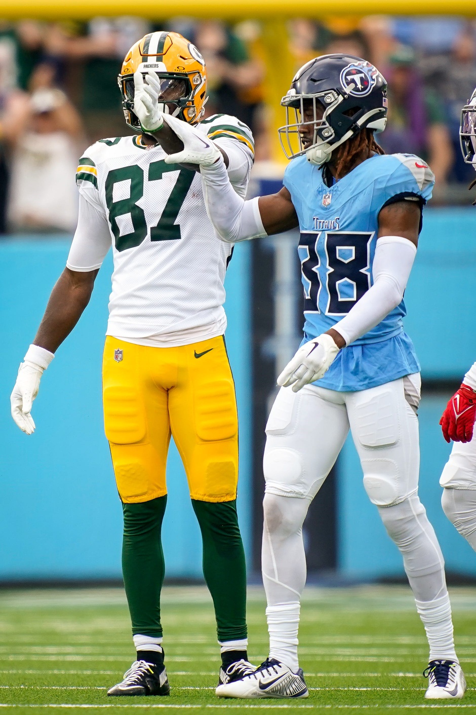 Green Bay Packers wide receiver Romeo Doubs (87) celebrates bringing in a first down next to Tennessee Titans cornerback L'Jarius Sneed (38) during the second quarter at Nissan Stadium in Nashville, Tenn., Sunday, Sept. 22, 2024. © Andrew Nelles / The Tennessean / USA TODAY NETWORK via Imagn Images