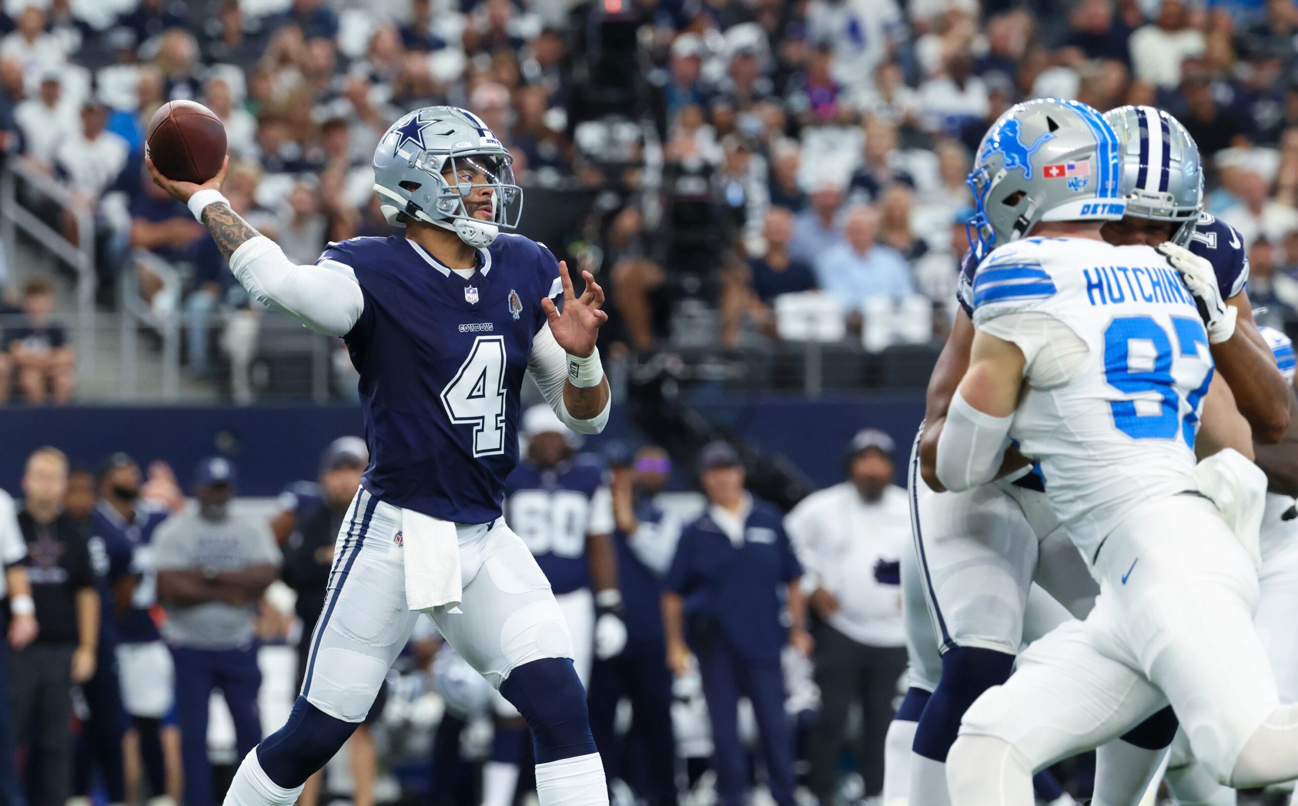 Oct 13, 2024; Arlington, Texas, USA; Dallas Cowboys quarterback Dak Prescott (4) throws as Detroit Lions defensive end Aidan Hutchinson (97) rushes during the first quarter at AT&T Stadium. Mandatory Credit: Kevin Jairaj-Imagn Images