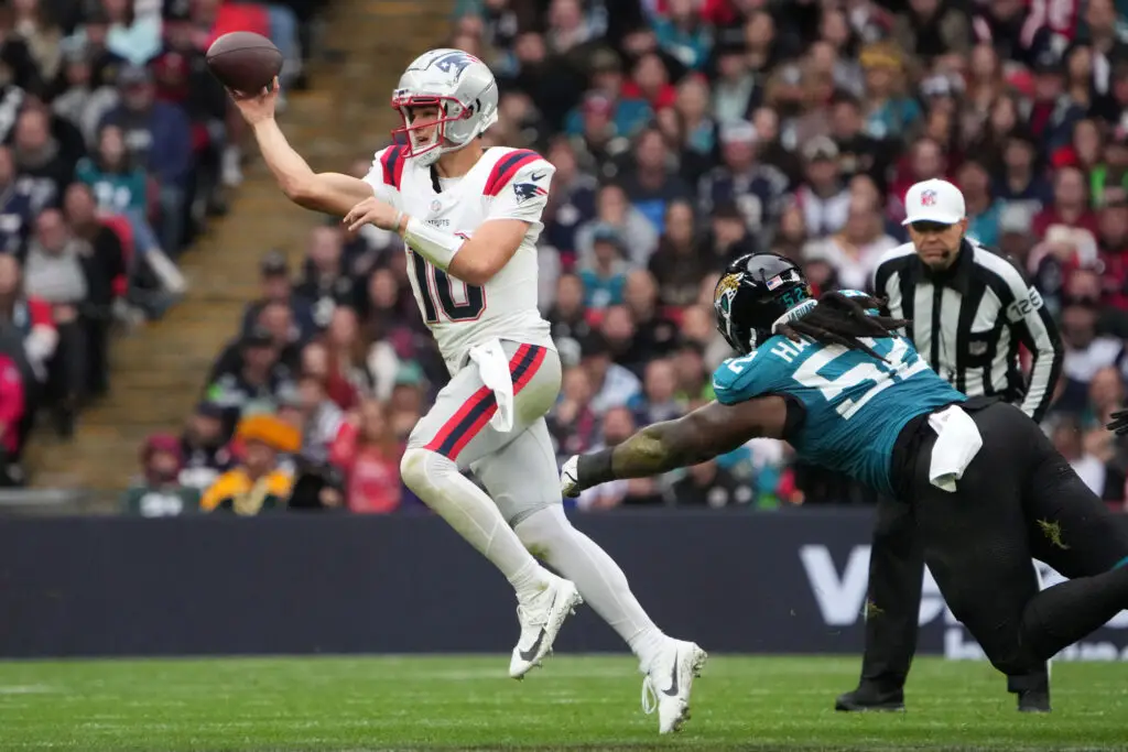 Oct 20, 2024; London, United Kingdom; New England Patriots quarterback Drake Maye (10) throws the ball against Jacksonville Jaguars defensive tackle DaVon Hamilton (52) in the first half of an NFL International Series game at Wembley Stadium. Mandatory Credit: Kirby Lee-Imagn Images