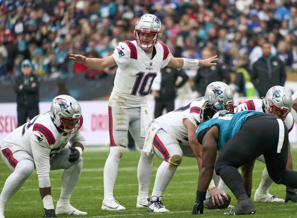 Oct 20, 2024; London, United Kingdom; New England Patriots quarterback Drake Maye (10) signs to players in the first half during an NFL International Series game at Wembley Stadium. Mandatory Credit: Peter van den Berg-Imagn Images