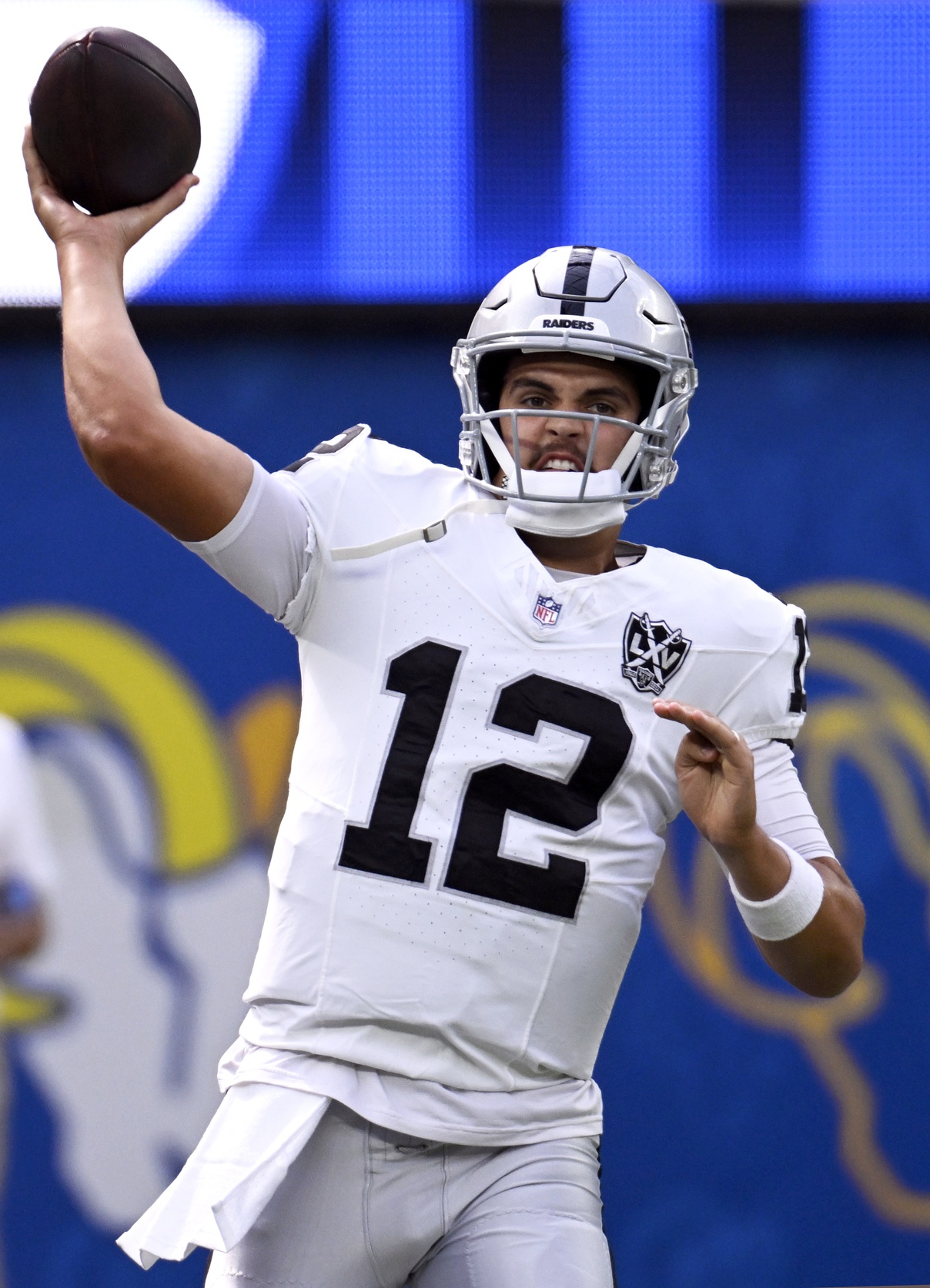 Oct 20, 2024; Inglewood, California, USA; Las Vegas Raiders quarterback Aidan O'Connell (12) throws a pass during warmups before the game against the Los Angeles Rams at SoFi Stadium. Mandatory Credit: Alex Gallardo-Imagn Images