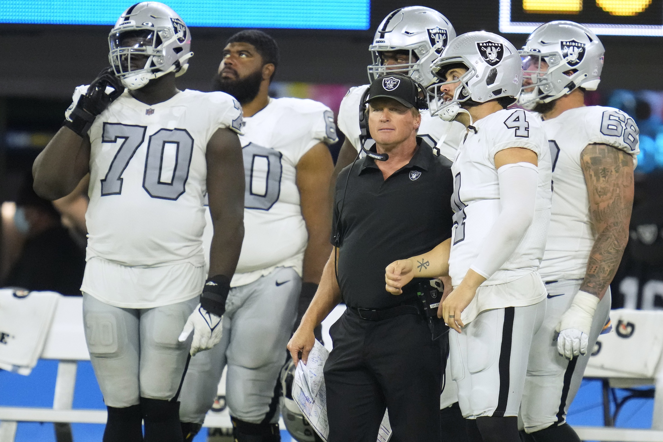 Oct 4, 2021; Inglewood, California, USA; Las Vegas Raiders head coach Jon Gruden talks with quarterback Derek Carr (4) during the second half against the Los Angeles Chargers at SoFi Stadium. Mandatory Credit: Robert Hanashiro-Imagn Images