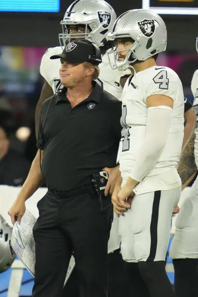 Oct 4, 2021; Inglewood, California, USA; Las Vegas Raiders head coach Jon Gruden talks with quarterback Derek Carr (4) during the second half against the Los Angeles Chargers at SoFi Stadium. Mandatory Credit: Robert Hanashiro-USA TODAY Sports Cowboys