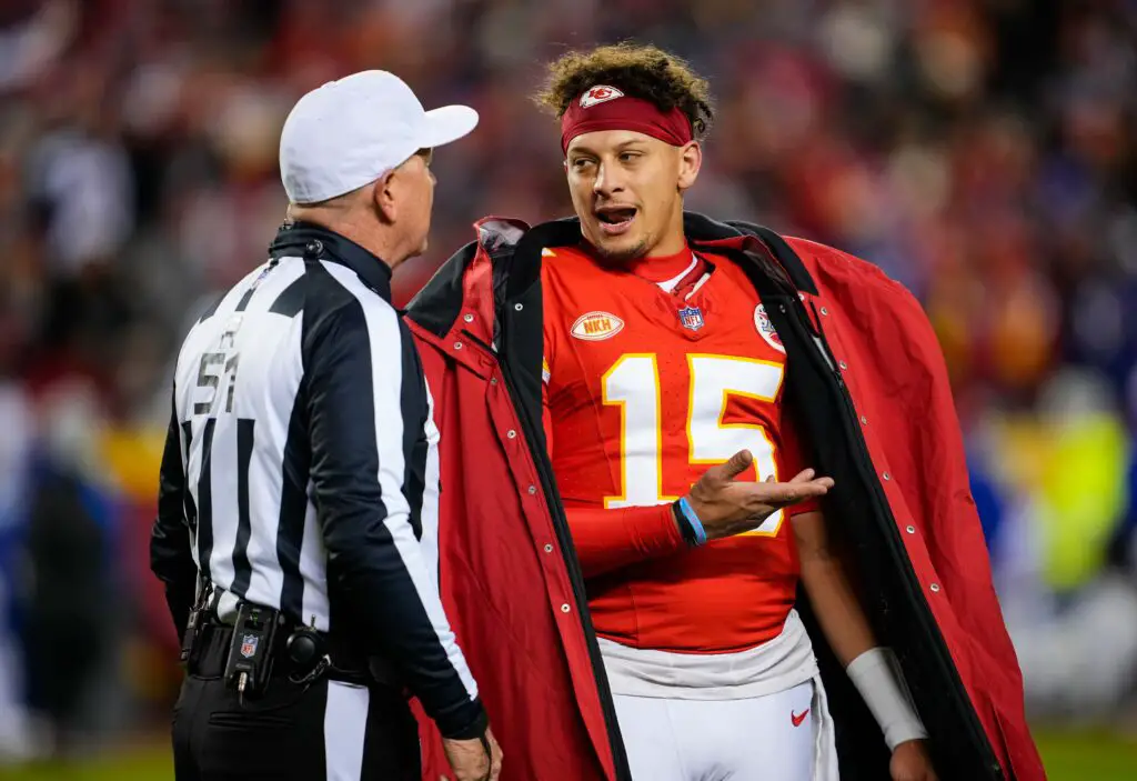 Dec 10, 2023; Kansas City, Missouri, USA; Kansas City Chiefs quarterback Patrick Mahomes (15) talks with referee Carl Cheffers (51) after penalty during the second half against the Buffalo Bills at GEHA Field at Arrowhead Stadium. Mandatory Credit: Jay Biggerstaff-USA TODAY Sports