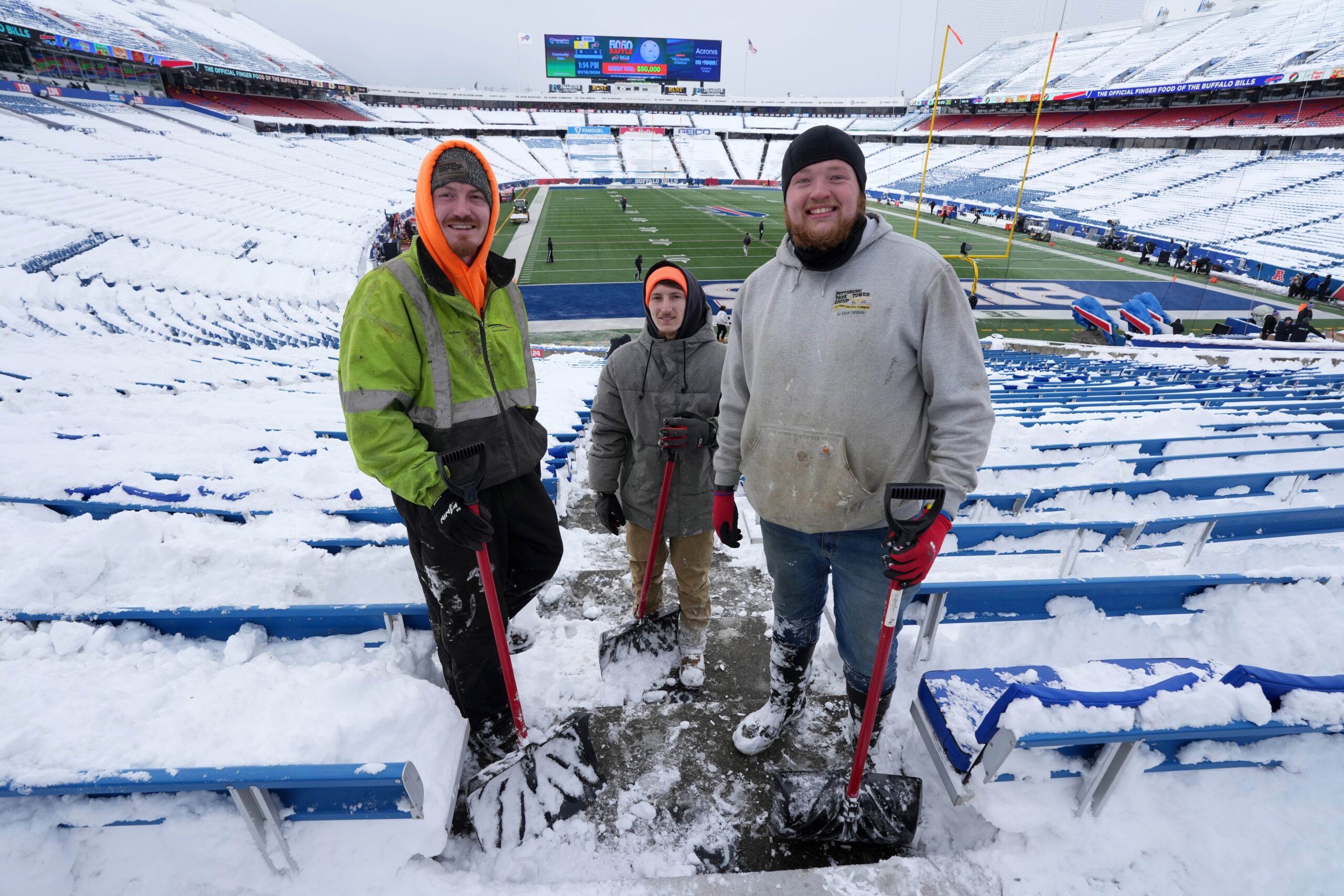 Jan 15, 2024; Orchard Park, New York, USA; Workers clear snow at the 2024 AFC wild card game between the Pittsburgh Steelers and the Buffalo Bills at Highmark Stadium. Mandatory Credit: Kirby Lee-Imagn Images