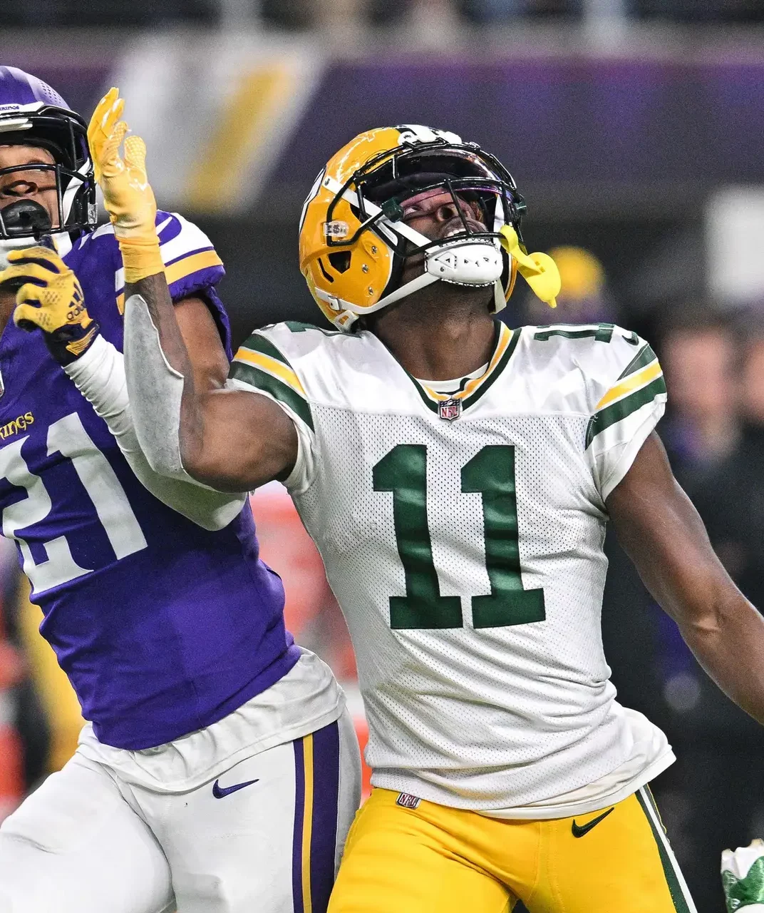 Dec 31, 2023; Minneapolis, Minnesota, USA; Green Bay Packers wide receiver Jayden Reed (11) scores a touchdown as Minnesota Vikings cornerback Akayleb Evans (21) and safety Camryn Bynum (24) attempt to make the tackle during the second quarter at U.S. Bank Stadium. Mandatory Credit: Jeffrey Becker-USA TODAY Sports