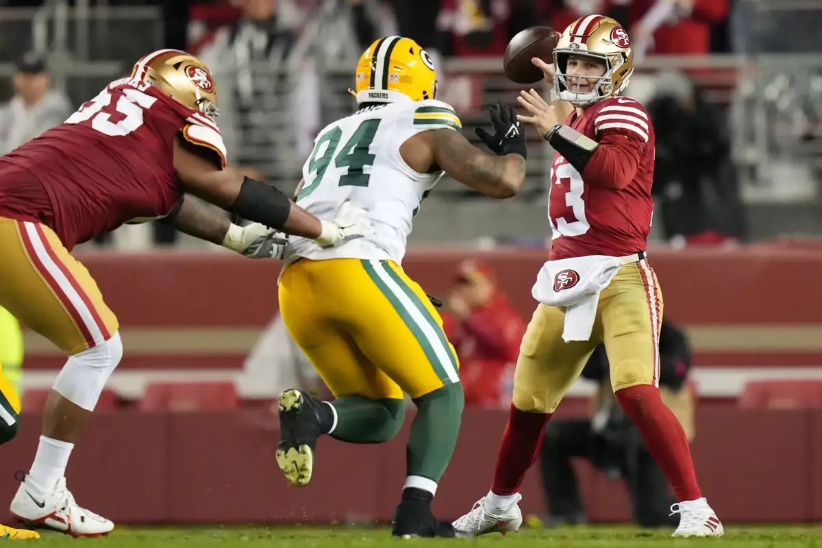 January 20, 2024; Santa Clara, CA, USA; San Francisco 49ers quarterback Brock Purdy (13) passes under pressure from Green Bay Packers defensive end Karl Brooks (94) during the third quarter in a 2024 NFC divisional round game at Levi's Stadium. Mandatory Credit: Kyle Terada-Imagn Images