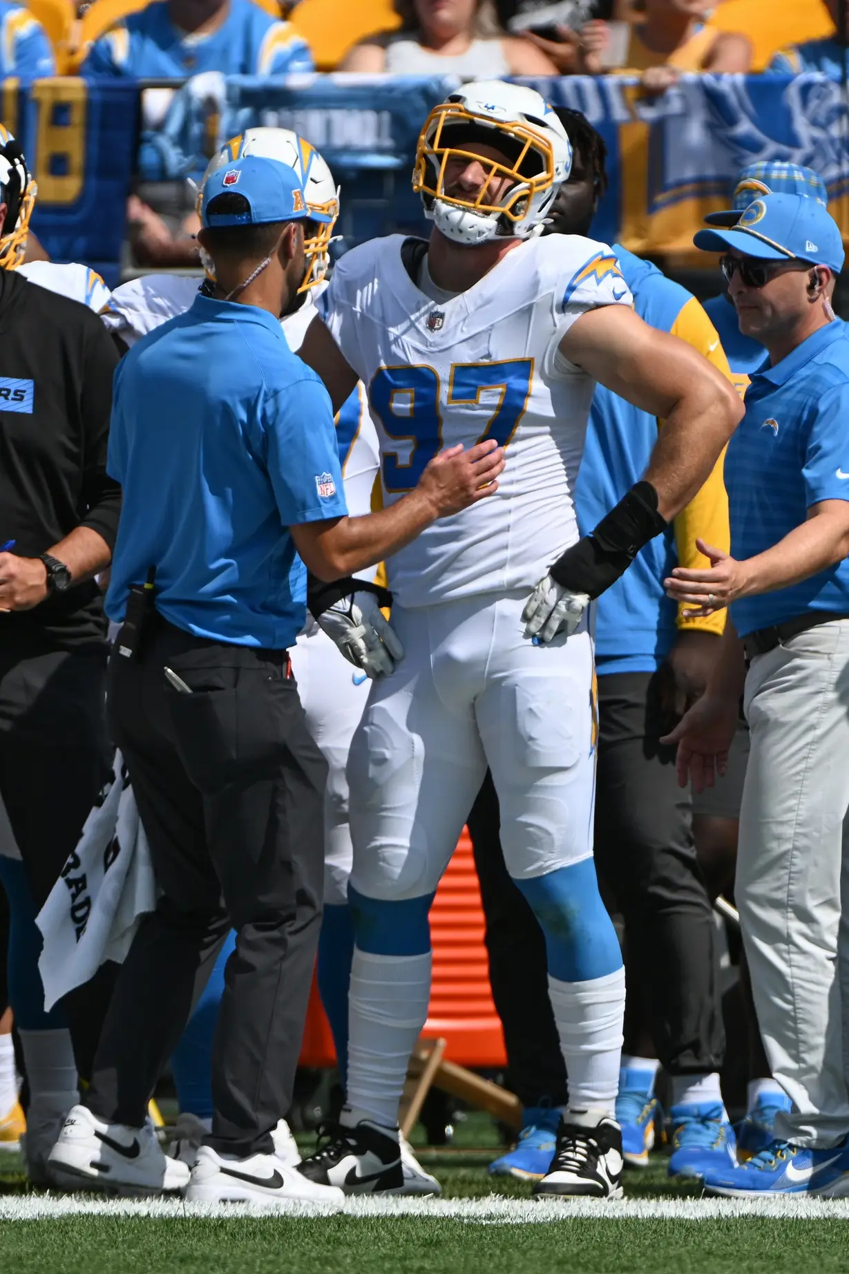 Sep 22, 2024; Pittsburgh, Pennsylvania, USA; Los Angeles Chargers linebacker Joey Bosa (97) receives attention on the sideline during the first quarter against the Pittsburgh Steelers at Acrisure Stadium. Mandatory Credit: Barry Reeger-Imagn Images