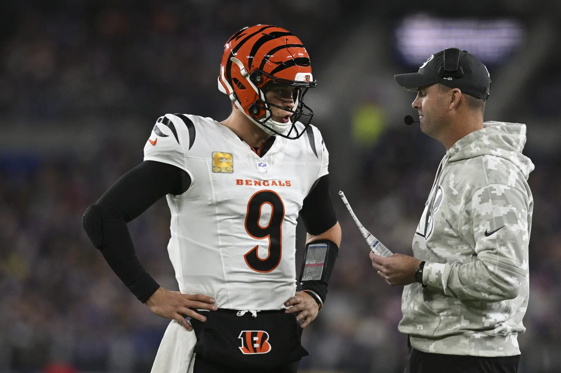 Nov 7, 2024; Baltimore, Maryland, USA; Cincinnati Bengals quarterback Joe Burrow (9) speaks with Cincinnati Bengals head coach Zac Taylor during the first quarter against the Baltimore Ravens at M&T Bank Stadium. Mandatory Credit: Tommy Gilligan-Imagn Images