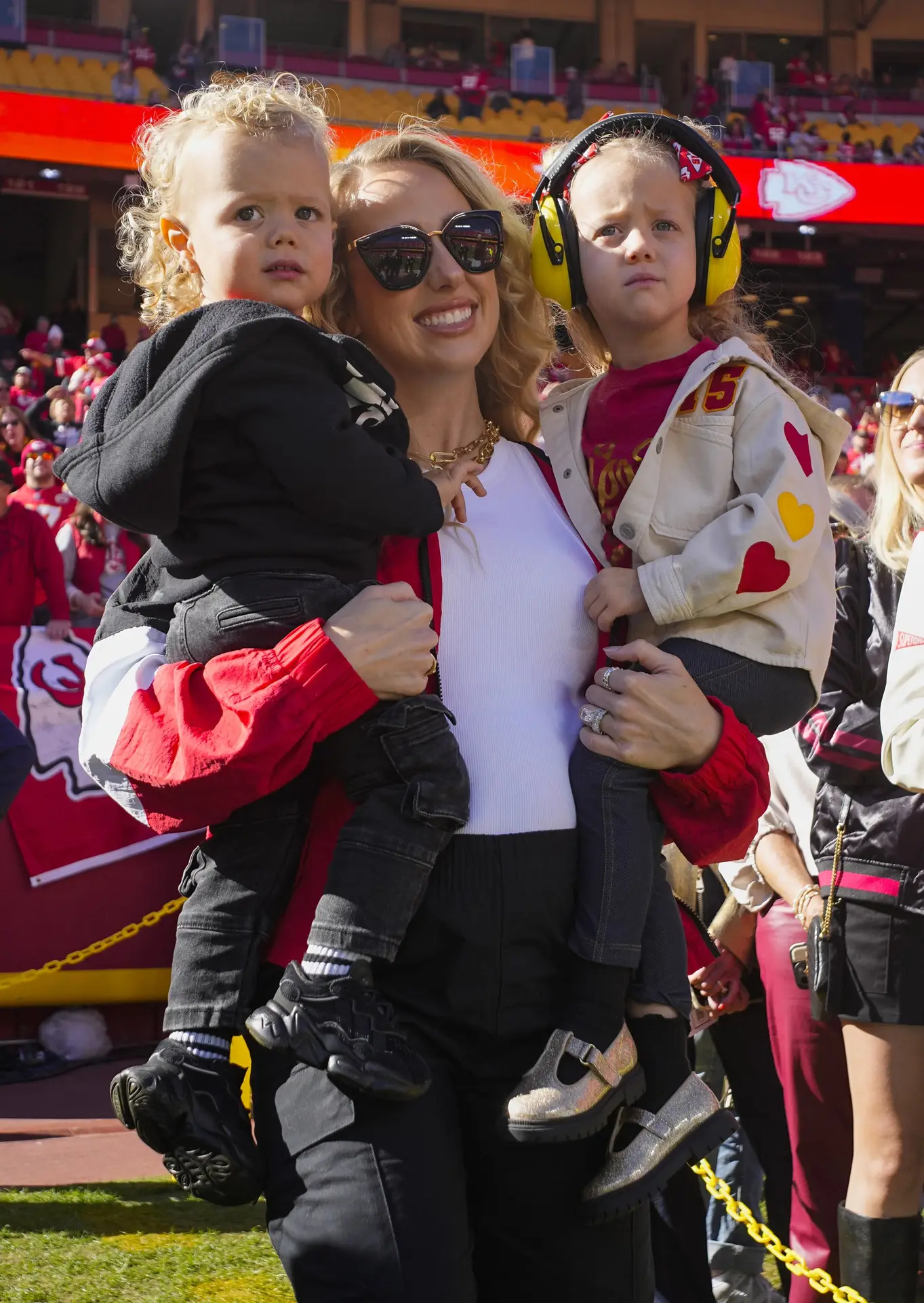 Nov 10, 2024; Kansas City, Missouri, USA; Brittany Mahomes and children watch warmups prior to game between the Kansas City Chiefs and the Denver Broncos at GEHA Field at Arrowhead Stadium. Mandatory Credit: Jay Biggerstaff-Imagn Images