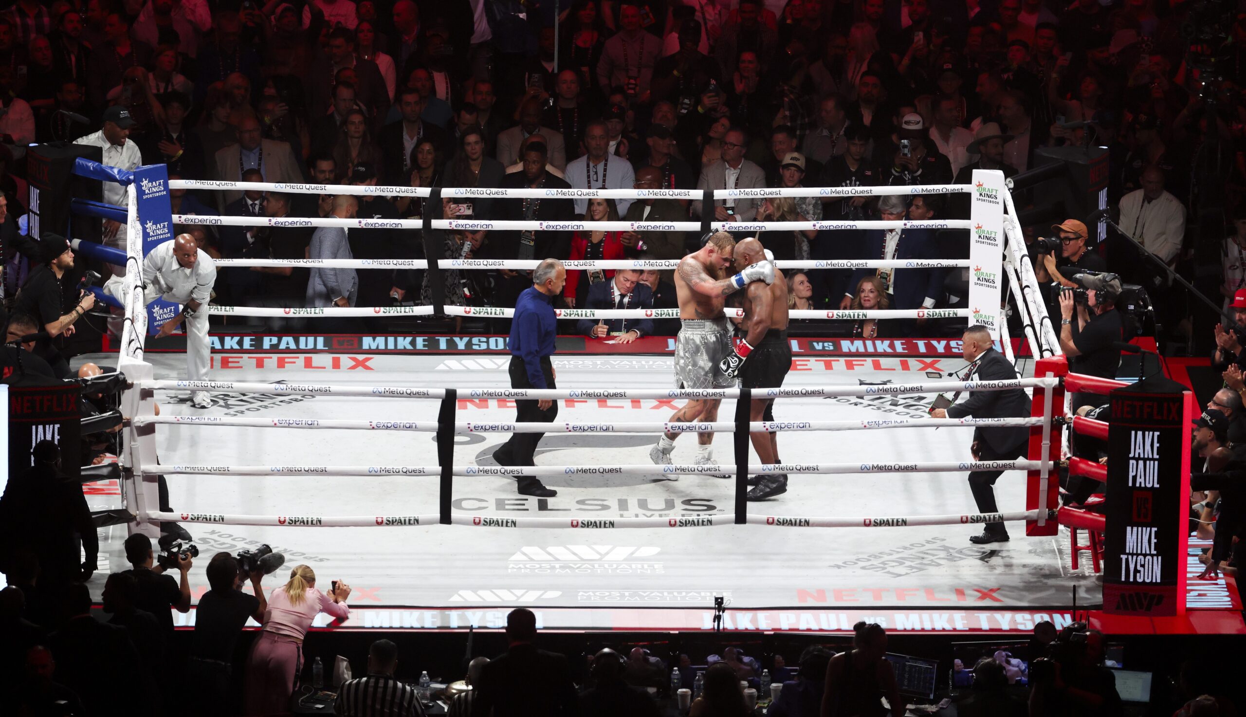 Nov 15, 2024; Arlington, Texas, UNITED STATES; Jake Paul hugs Mike Tyson during their fight at AT&T Stadium. Mandatory Credit: Kevin Jairaj-Imagn Images