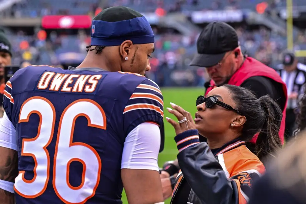 Nov 17, 2024; Chicago, Illinois, USA; Chicago Bears defensive back Jonathan Owens (36) is greeted by wife and United States gymnast Simone Biles before the game against the Green Bay Packers at Soldier Field. Mandatory Credit: Daniel Bartel-Imagn Images