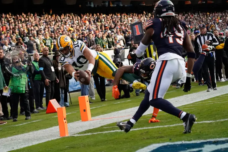 Nov 17, 2024; Chicago, Illinois, USA; Green Bay Packers quarterback Jordan Love (10) dives into the end zone against Chicago Bears safety Kevin Byard III (31) during the second half at Soldier Field. Mandatory Credit: David Banks-Imagn Images