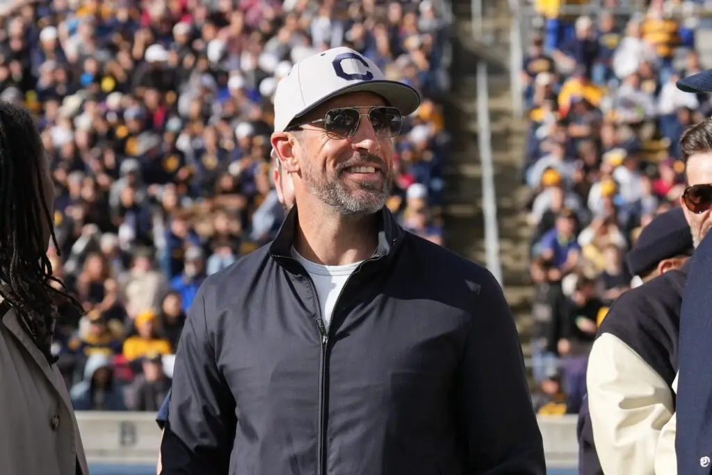 Nov 23, 2024; Berkeley, California, USA; California Golden Bears former quarterback Aaron Rodgers stands on the field before the start of the second quarter against the Stanford Cardinal at California Memorial Stadium. Mandatory Credit: Darren Yamashita-Imagn Images