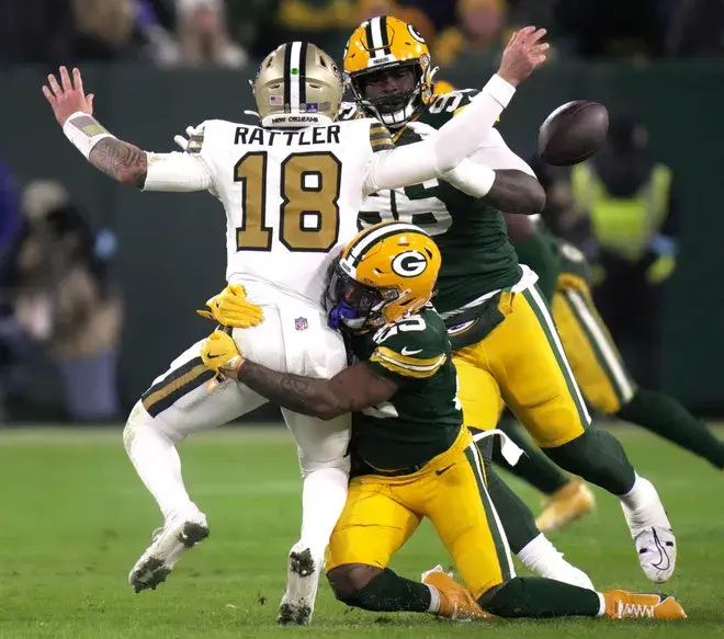 Green Bay Packers cornerback Keisean Nixon (25) forces a fumble by New Orleans Saints quarterback Spencer Rattler (18) during the second quarter of their game Monday, December 23, 2024 at Lambeau Field in Green Bay, Wisconsin. The Packers recovered the ball.Mark Hoffman/Milwaukee Journal Sentinel