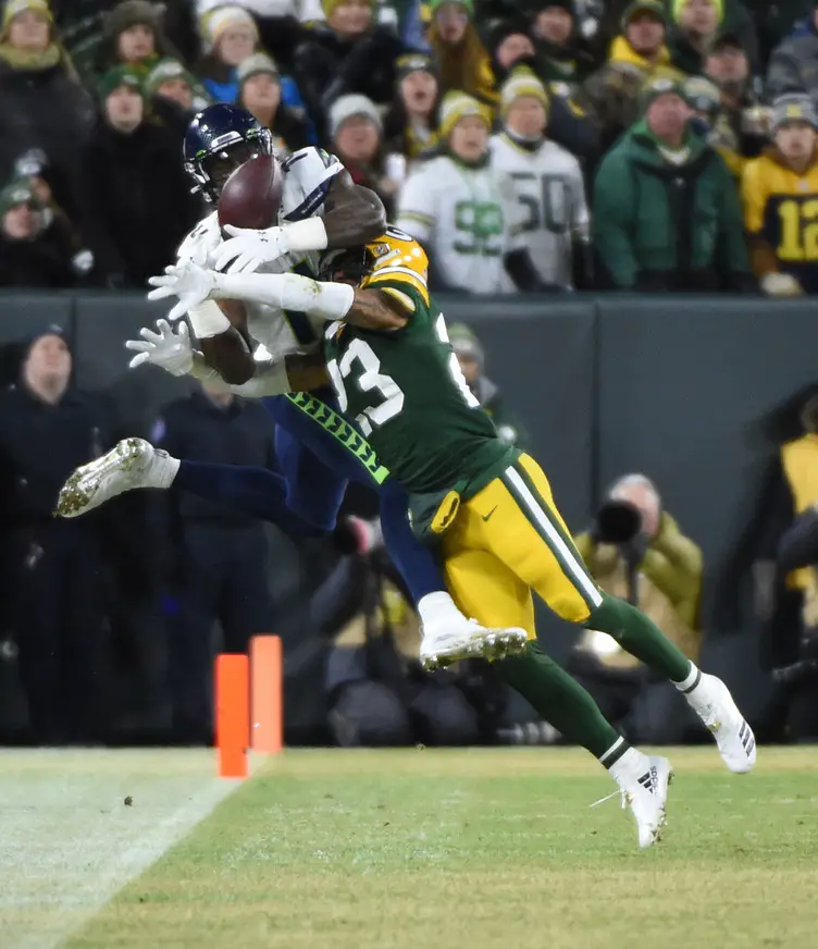 Jan 12, 2020; Green Bay, WI, USA; Green Bay Packers cornerback Jaire Alexander (23) breaks up a pass intended for Seattle Seahawks wide receiver D.K. Metcalf (14) in the first quarter of a NFC Divisional Round playoff football game at Lambeau Field. Mandatory Credit: Benny Sieu-Imagn Images