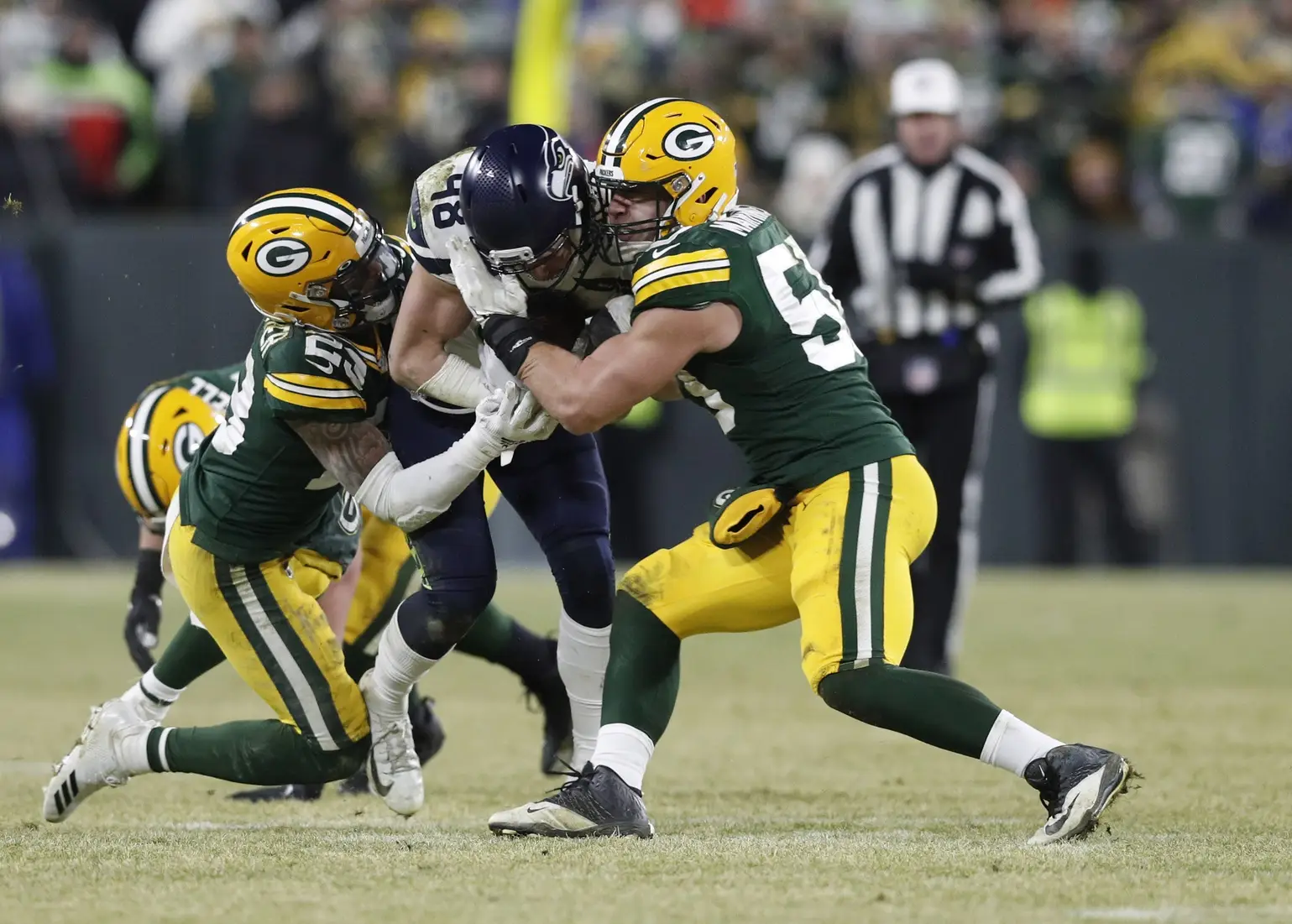 Jan 12, 2020; Green Bay, WI, USA; Seattle Seahawks tight end Jacob Hollister (48) is tackled by Green Bay Packers cornerback Jaire Alexander (23) and inside linebacker Blake Martinez (50) in the third quarter of a NFC Divisional Round playoff football game at Lambeau Field. Mandatory Credit: Jeff Hanisch-Imagn Images