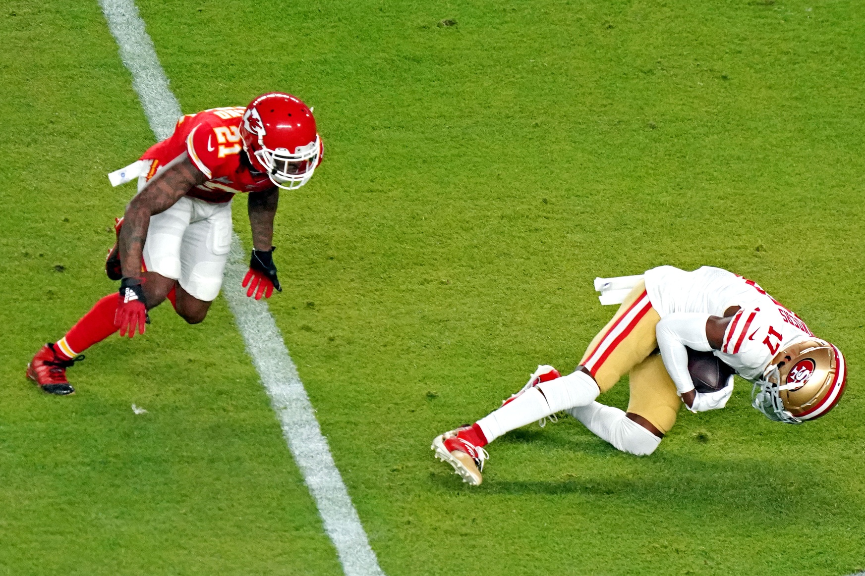 Feb 2, 2020; Miami Gardens, Florida, USA; San Francisco 49ers wide receiver Emmanuel Sanders (17) makes a catch against Kansas City Chiefs defensive back Bashaud Breeland (21) during the second quarter in Super Bowl LIV at Hard Rock Stadium. Mandatory Credit: Kirby Lee-Imagn Images