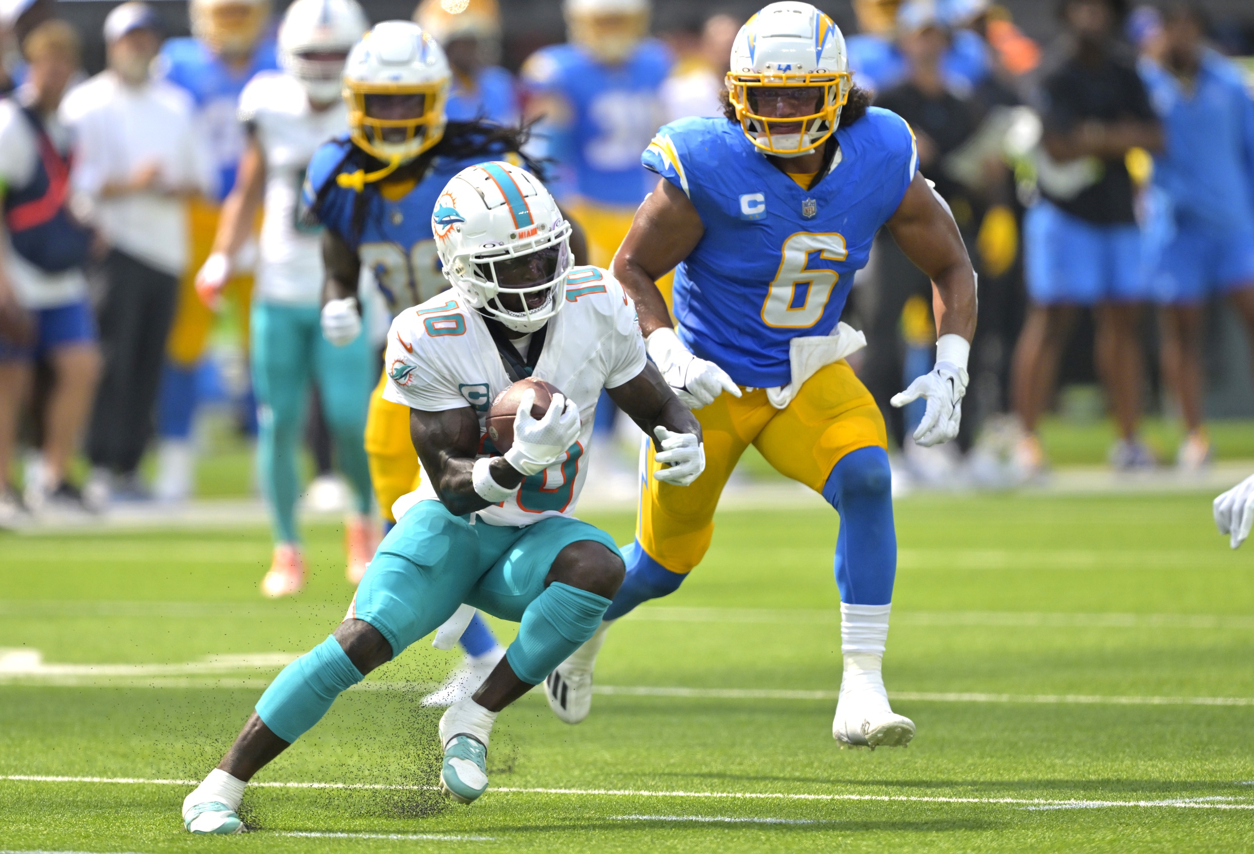 Sep 10, 2023; Inglewood, California, USA; Miami Dolphins wide receiver Tyreek Hill (10) hangs on to the ball for a complete pass and first down in front of Los Angeles Chargers linebacker Eric Kendricks (6) in the first half at SoFi Stadium. Mandatory Credit: Jayne Kamin-Oncea-Imagn Images