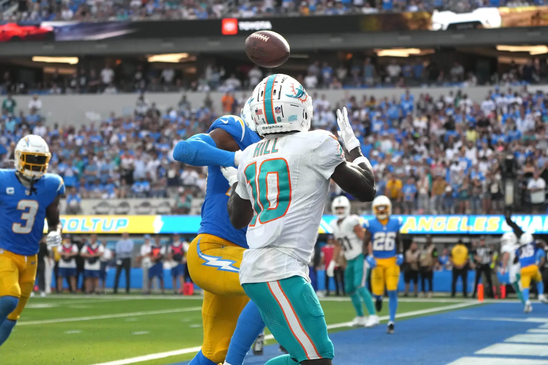 Sep 10, 2023; Inglewood, California, USA; Miami Dolphins wide receiver Tyreek Hill (10) catches a 4-yard touchdown pass against Los Angeles Chargers cornerback Michael Davis (43) in the fourth quarter at SoFi Stadium. Mandatory Credit: Kirby Lee-Imagn Images