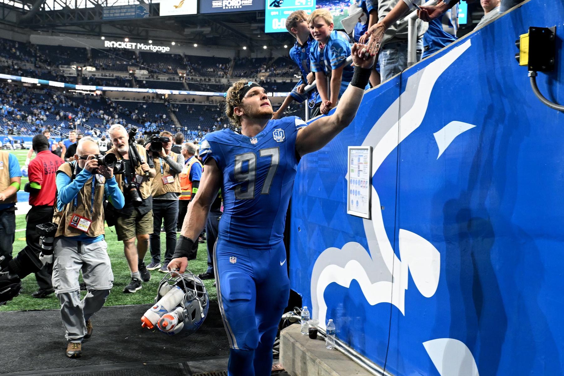 Oct 8, 2023; Detroit, Michigan, USA; Detroit Lions defensive end Aidan Hutchinson (97) celebrates with the fans following the Lions win over the Carolina Panthers at Ford Field. Mandatory Credit: Lon Horwedel-Imagn Images