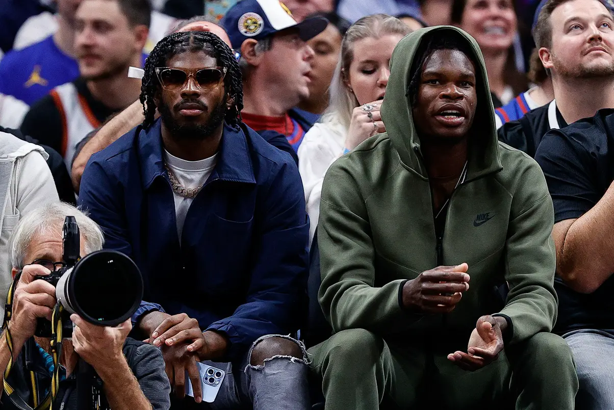 Oct 24, 2023; Denver, Colorado, USA; University of Colorado Buffaloes football players Shedeur Sanders (L) and Travis Hunter (R) watch during the third period between the Denver Nuggets and the Los Angeles Lakers at Ball Arena. Mandatory Credit: Isaiah J. Downing-Imagn Images