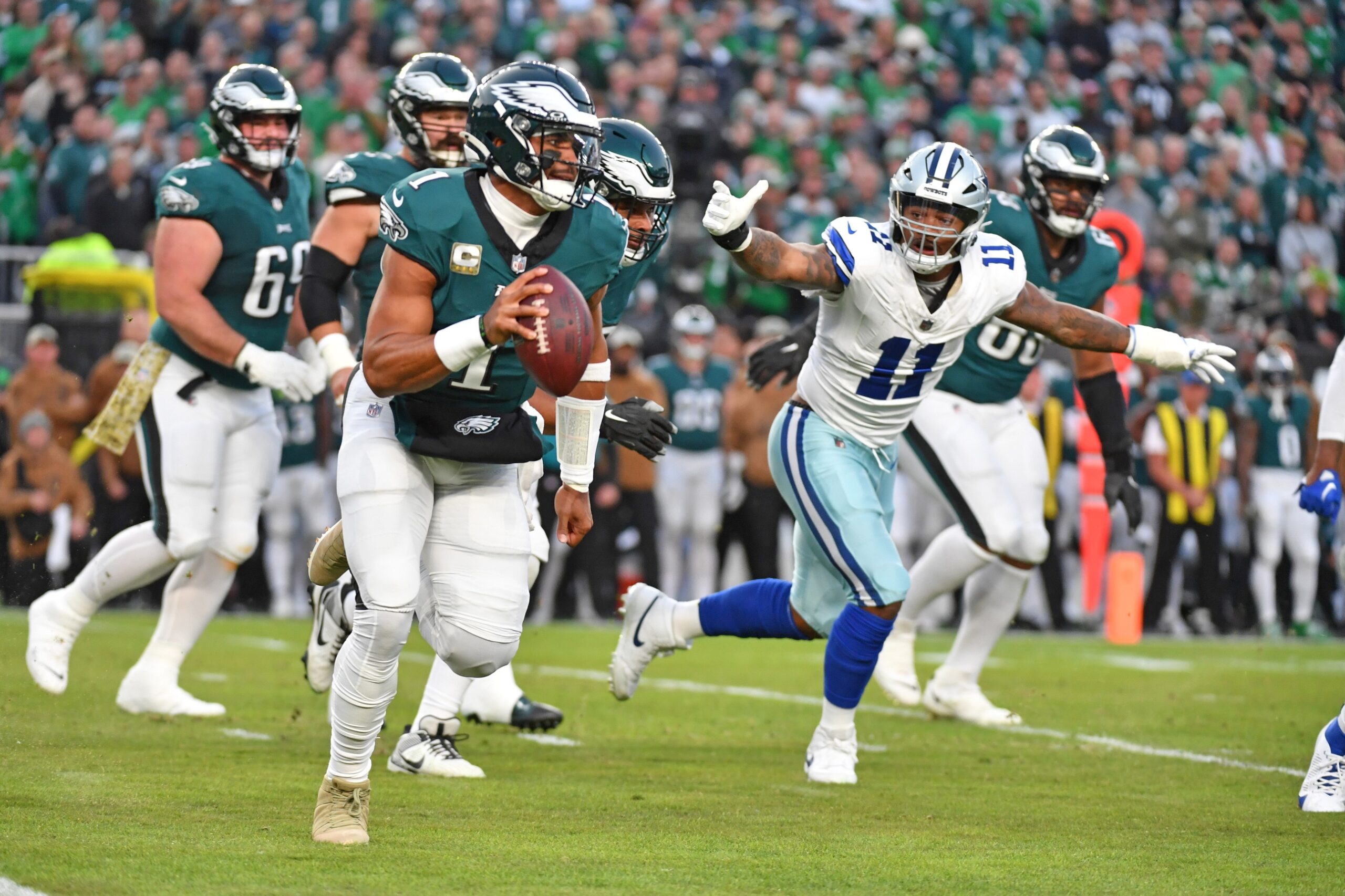 Nov 5, 2023; Philadelphia, Pennsylvania, USA; Philadelphia Eagles quarterback Jalen Hurts (1) runs away from pressure by Dallas Cowboys linebacker Micah Parsons (11) during the first quarter at Lincoln Financial Field. Mandatory Credit: Eric Hartline-Imagn Images