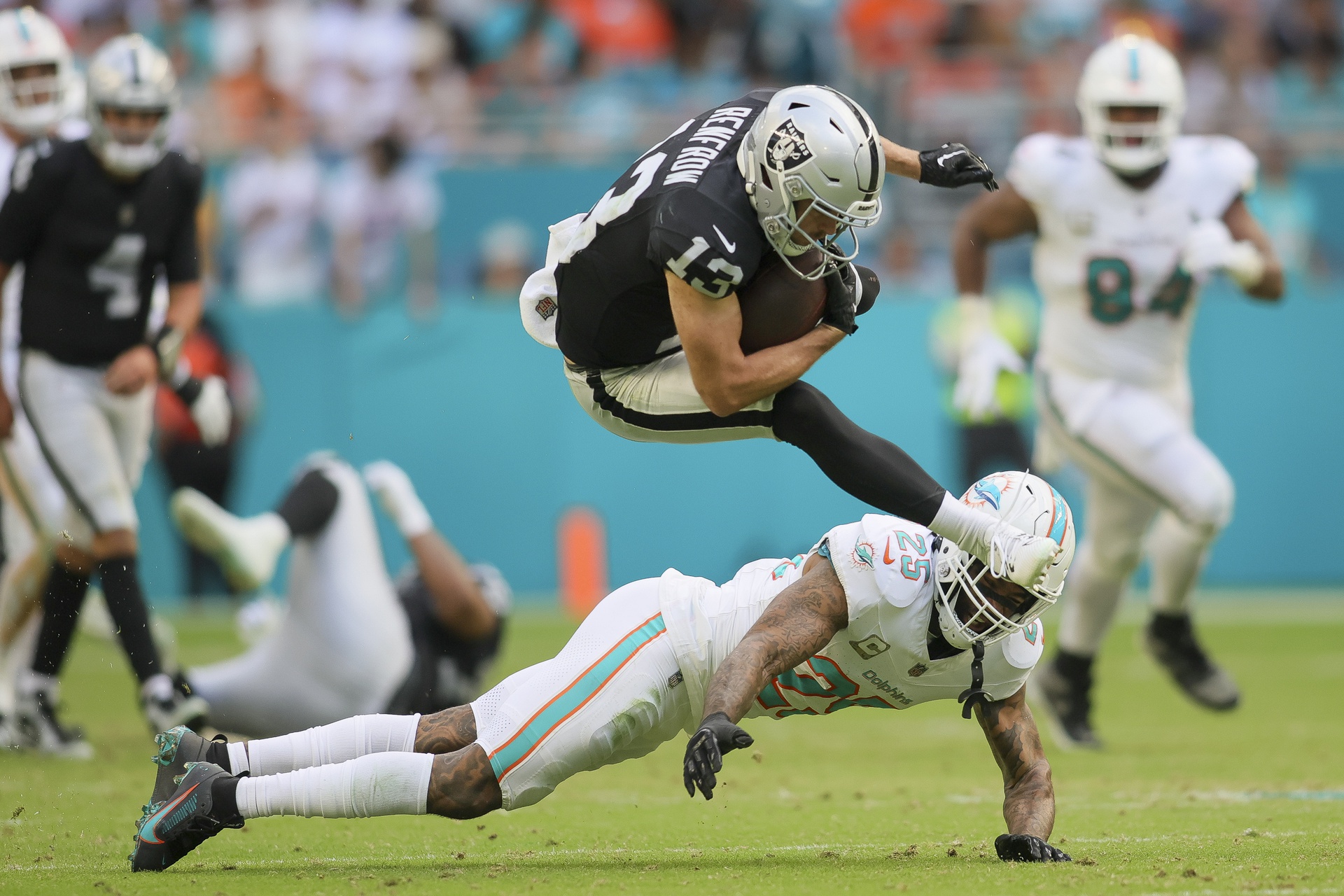 Nov 19, 2023; Miami Gardens, Florida, USA; Las Vegas Raiders wide receiver Hunter Renfrow (13) leaps over Miami Dolphins cornerback Xavien Howard (25) during the fourth quarter at Hard Rock Stadium. Mandatory Credit: Sam Navarro-Imagn Images (Cowboys)