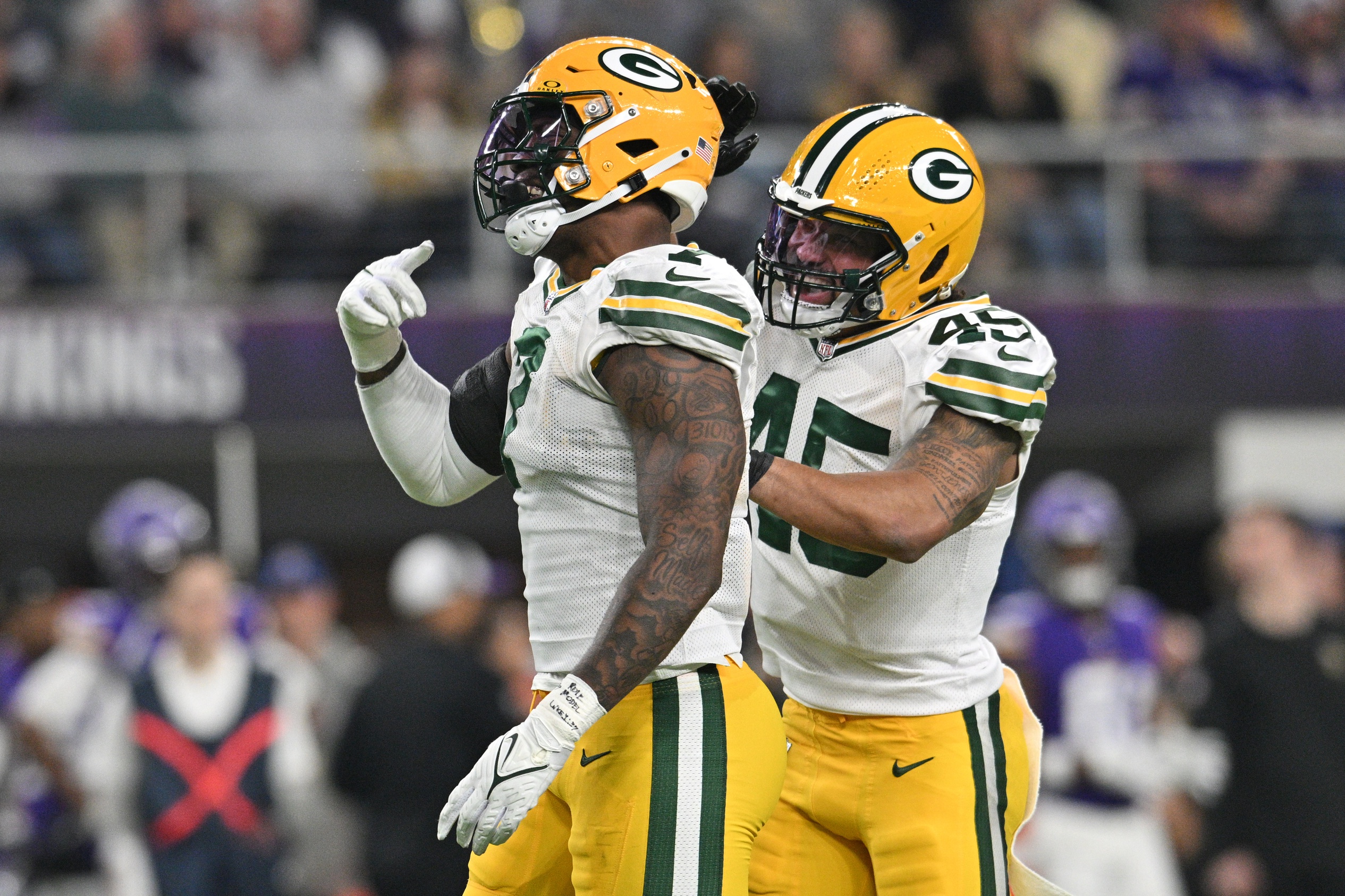 Dec 31, 2023; Minneapolis, Minnesota, USA; Green Bay Packers linebacker Quay Walker (7) and linebacker Eric Wilson (45) react after a sack by Walker against the Minnesota Vikings during the second quarter at U.S. Bank Stadium. Mandatory Credit: Jeffrey Becker-Imagn Images