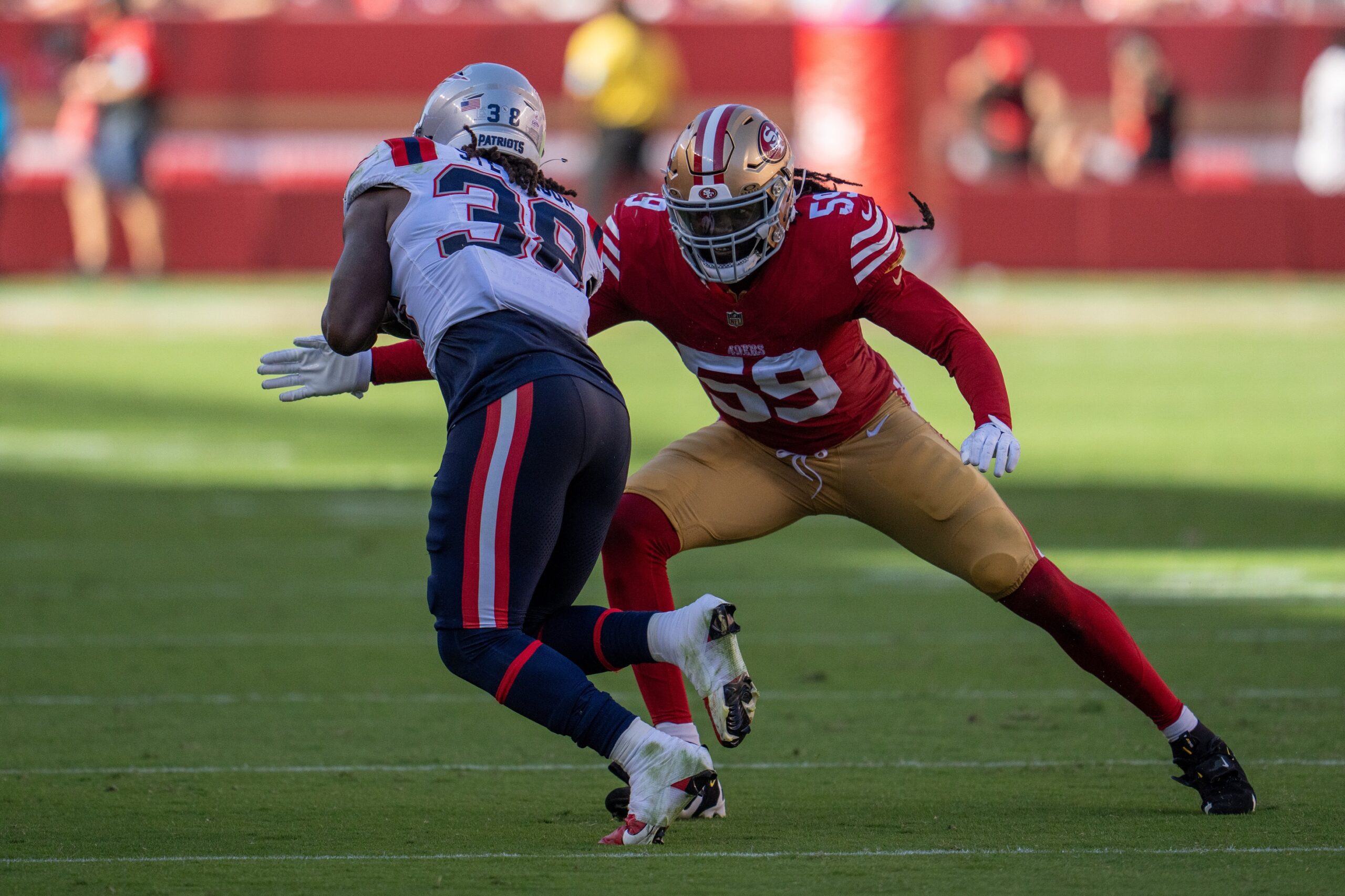 Sep 29, 2024; Santa Clara, California, USA; San Francisco 49ers linebacker De'Vondre Campbell (59) tackles New England Patriots running back Rhamondre Stevenson (38) during the fourth quarter at Levi's Stadium. Mandatory Credit: Neville E. Guard-Imagn Images