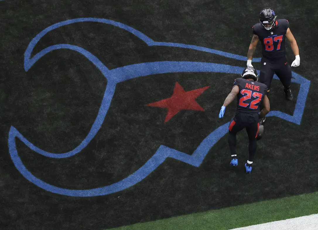 Oct 6, 2024; Houston, Texas, USA; Houston Texans tight end Cade Stover (87) celebrates running back Cam Akers (22) touchdown against the Buffalo Bills in the first quarter at NRG Stadium. Mandatory Credit: Thomas Shea-Imagn Images