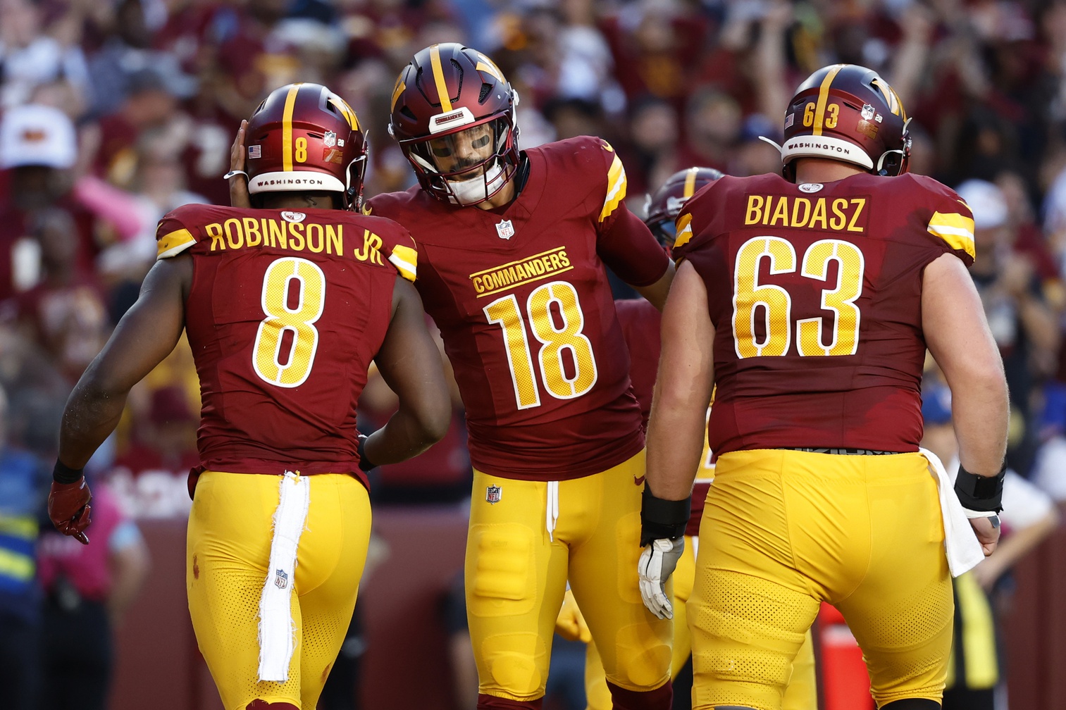 Oct 20, 2024; Landover, Maryland, USA; Washington Commanders running back Brian Robinson Jr. (8) celebrates with Commanders quarterback Marcus Mariota (18) after scoring a touchdown against the Carolina Panthers during the second quarter at Northwest Stadium. Mandatory Credit: Geoff Burke-Imagn Images