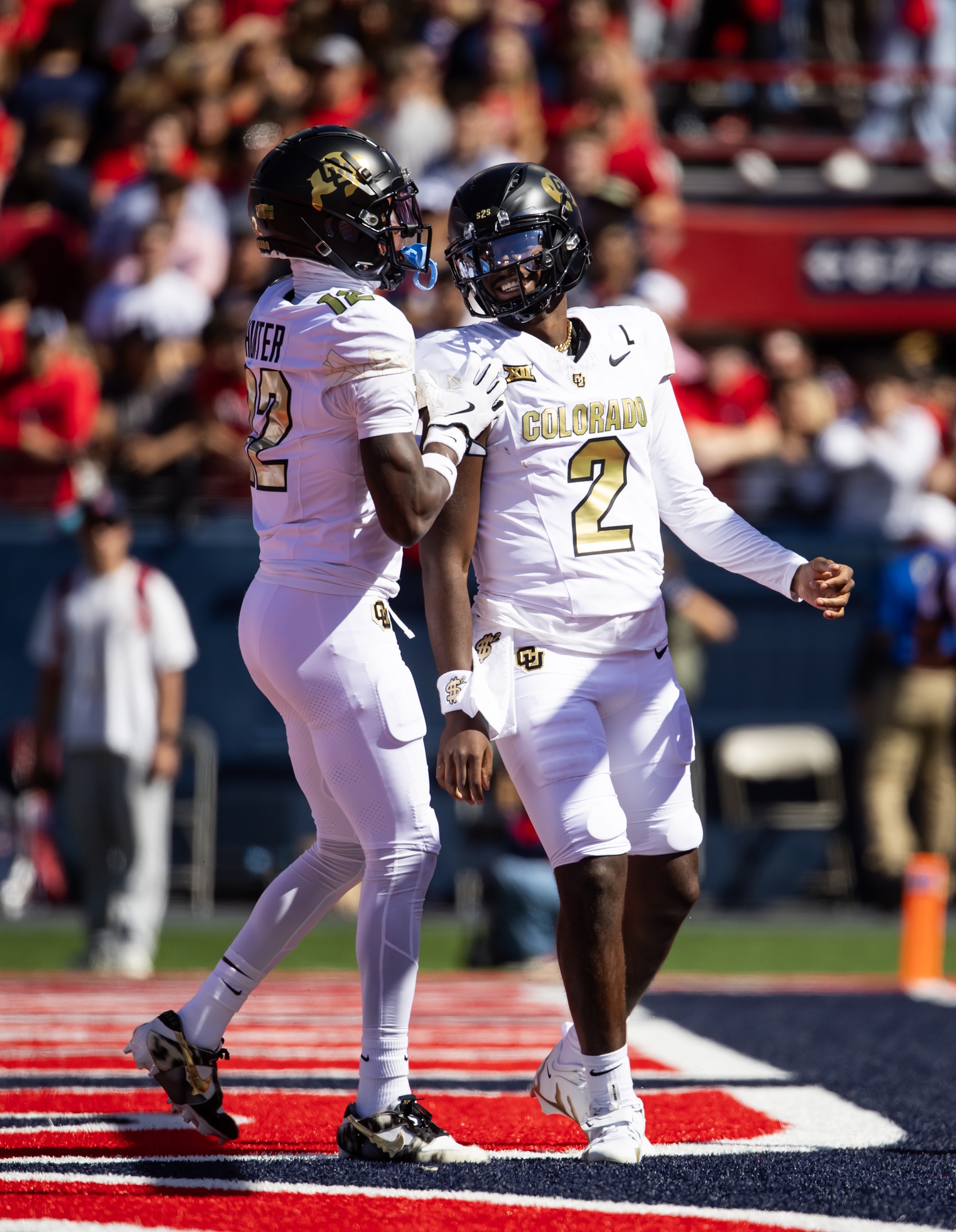 Oct 19, 2024; Tucson, Arizona, USA; Colorado Buffalos quarterback Shedeur Sanders (2) with wide receiver Travis Hunter (12) against the Arizona Wildcats at Arizona Stadium. Mandatory Credit: Mark J. Rebilas-Imagn Images